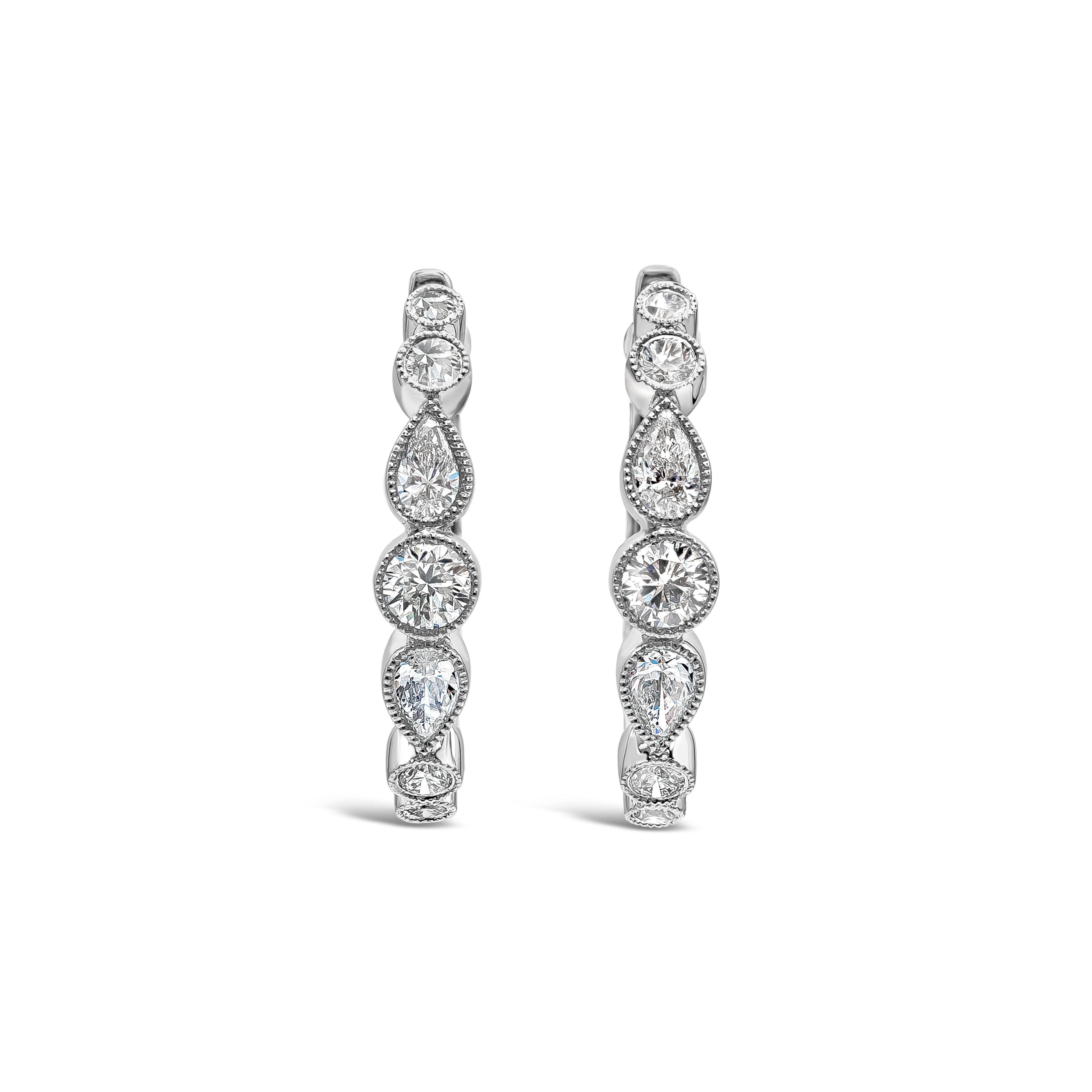 A unique piece of hoop earrings showcasing a row of alternating round and pear shape diamonds, Diamonds weigh 0.78 carats total and are approximately F-G color, VS-SI clarity. Set in a milgrain bezel made in 18k white gold. 

Roman Malakov is a