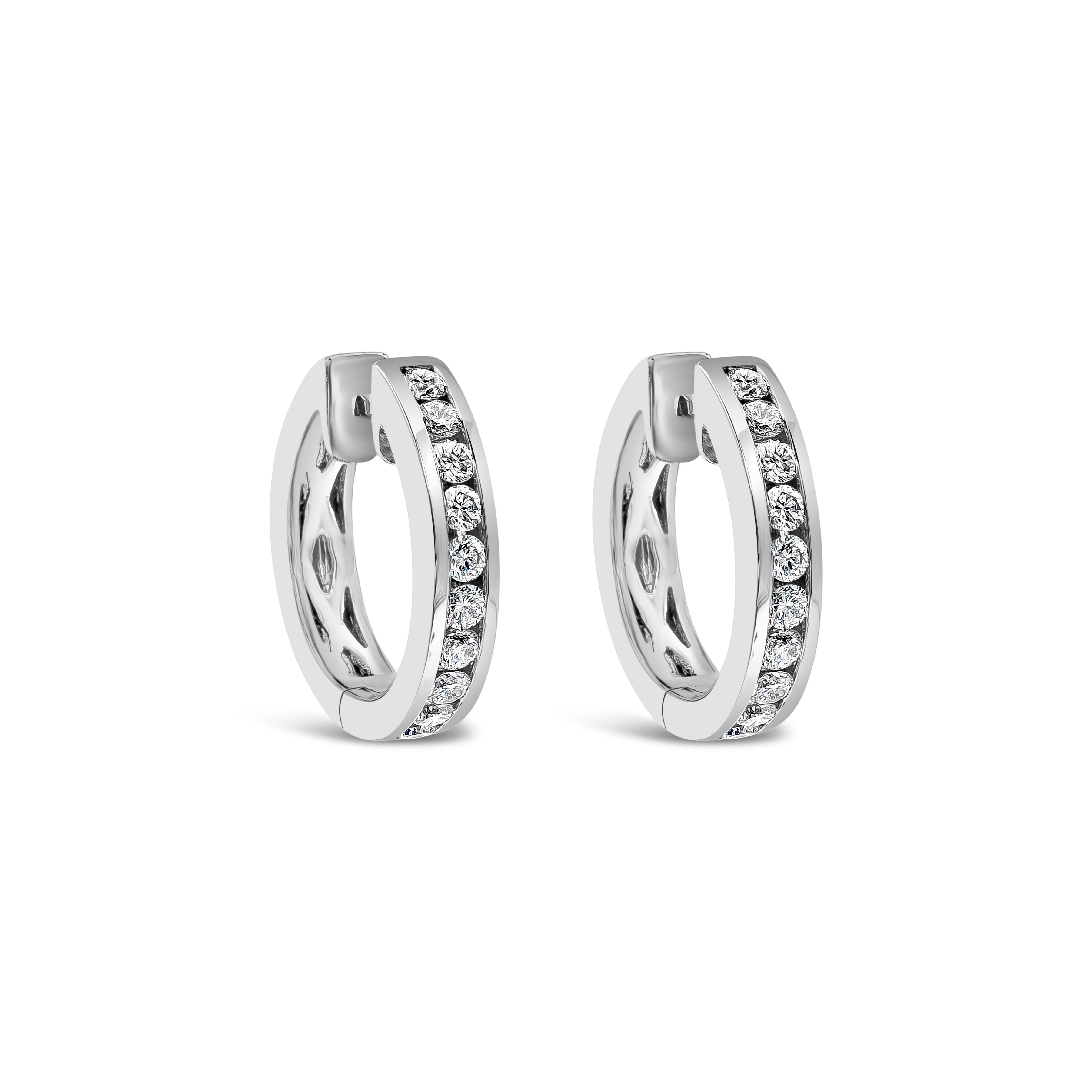 A simple pair of hoop earrings features a row of round brilliant diamonds, set in a channel setting made in 18k white gold. Diamonds weigh 0.34 carats total and are approximately F-G color, VS-SI clarity.

Style available in different price ranges.