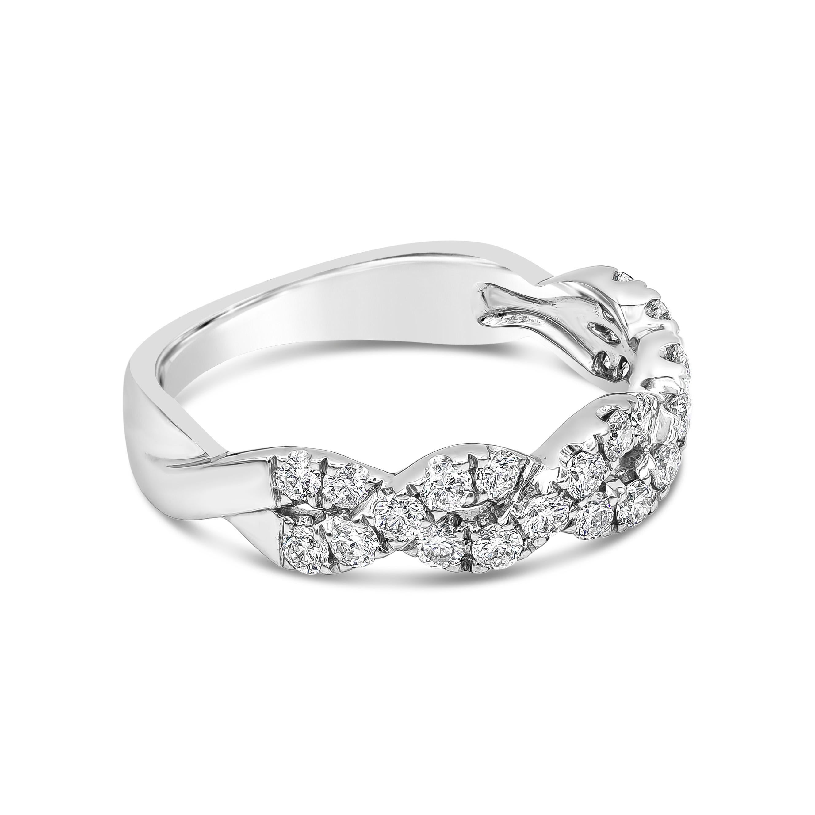 This unique take on the classic diamond wedding band features 0.62 carats total brilliant round diamonds set in 18k white gold. Two lines of sparkling diamonds intertwine to symbolize the infinite love between two people. Size 6.75 US resizable upon