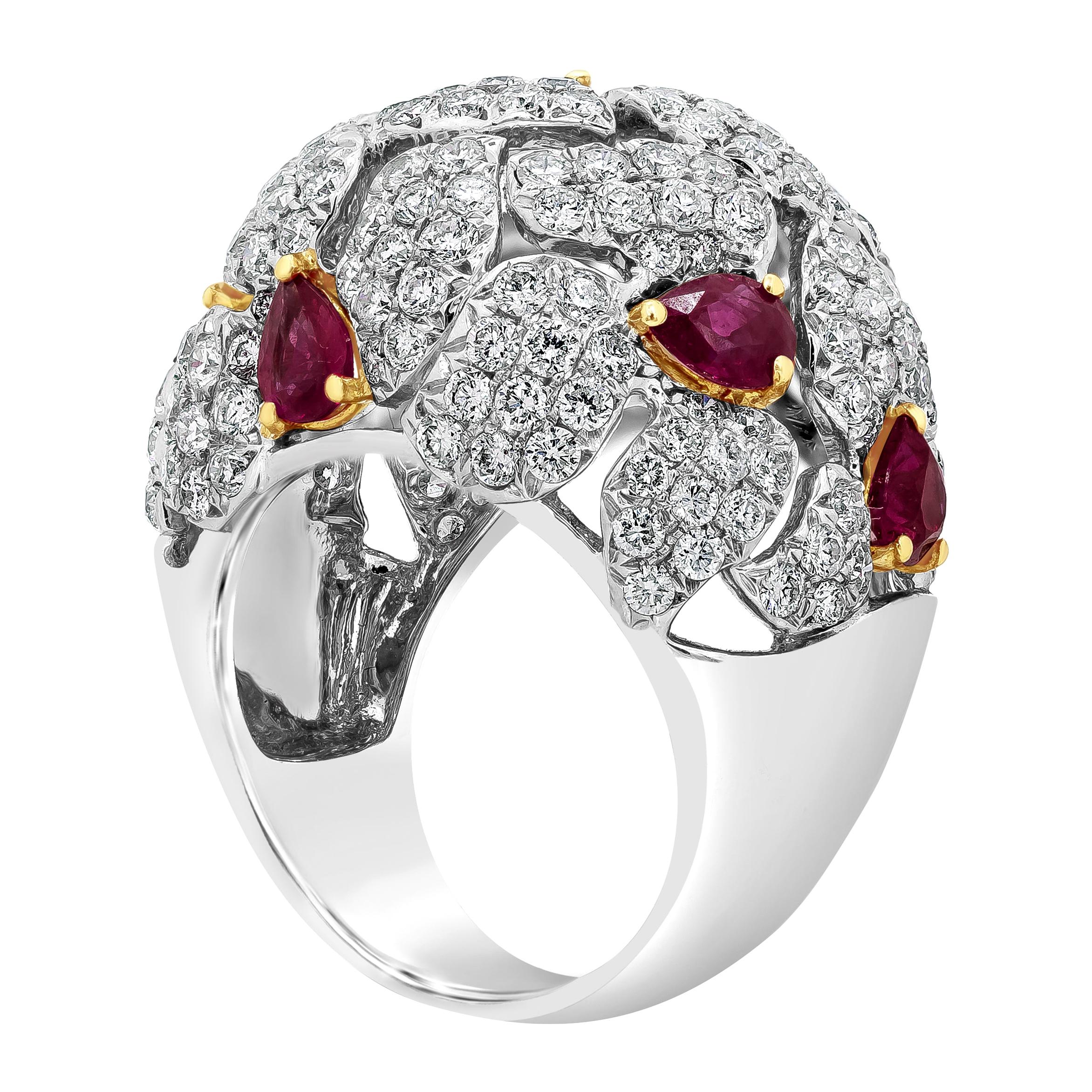 A very beautiful and fashionable ring showcasing a cluster of round brilliant diamonds accented with vibrant pear shape rubies, set in a dome open-work mounting made in 18k white gold. Diamonds weigh 3.76 carats total; rubies weigh 2.67 carats