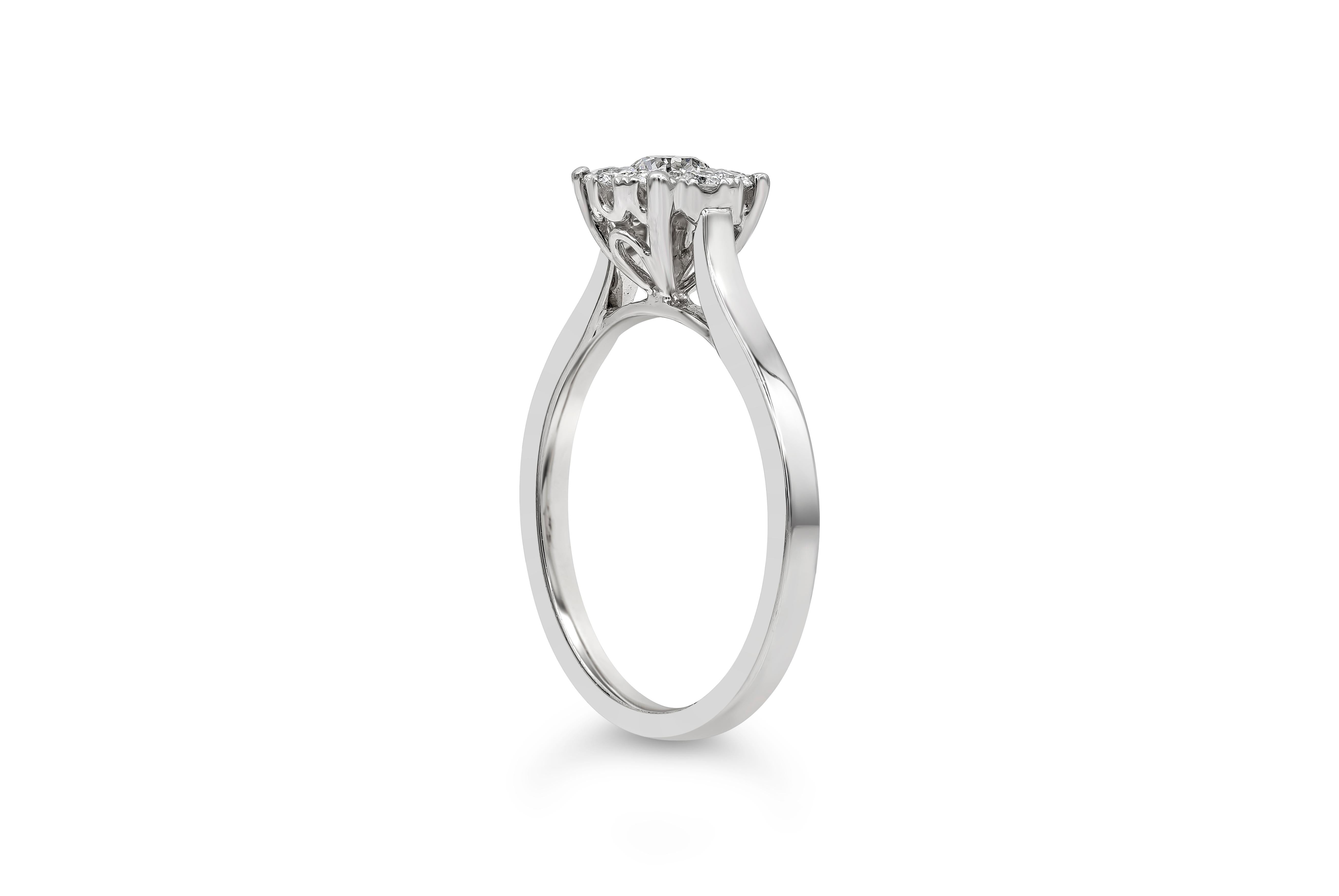 A unique solitaire engagement ring style showcasing a cluster of round brilliant diamonds making it look like one large center diamond, set in a classic four prong setting. Diamonds weigh 0.45 carats total. Finely made in 18K white gold. Size 6.5 US