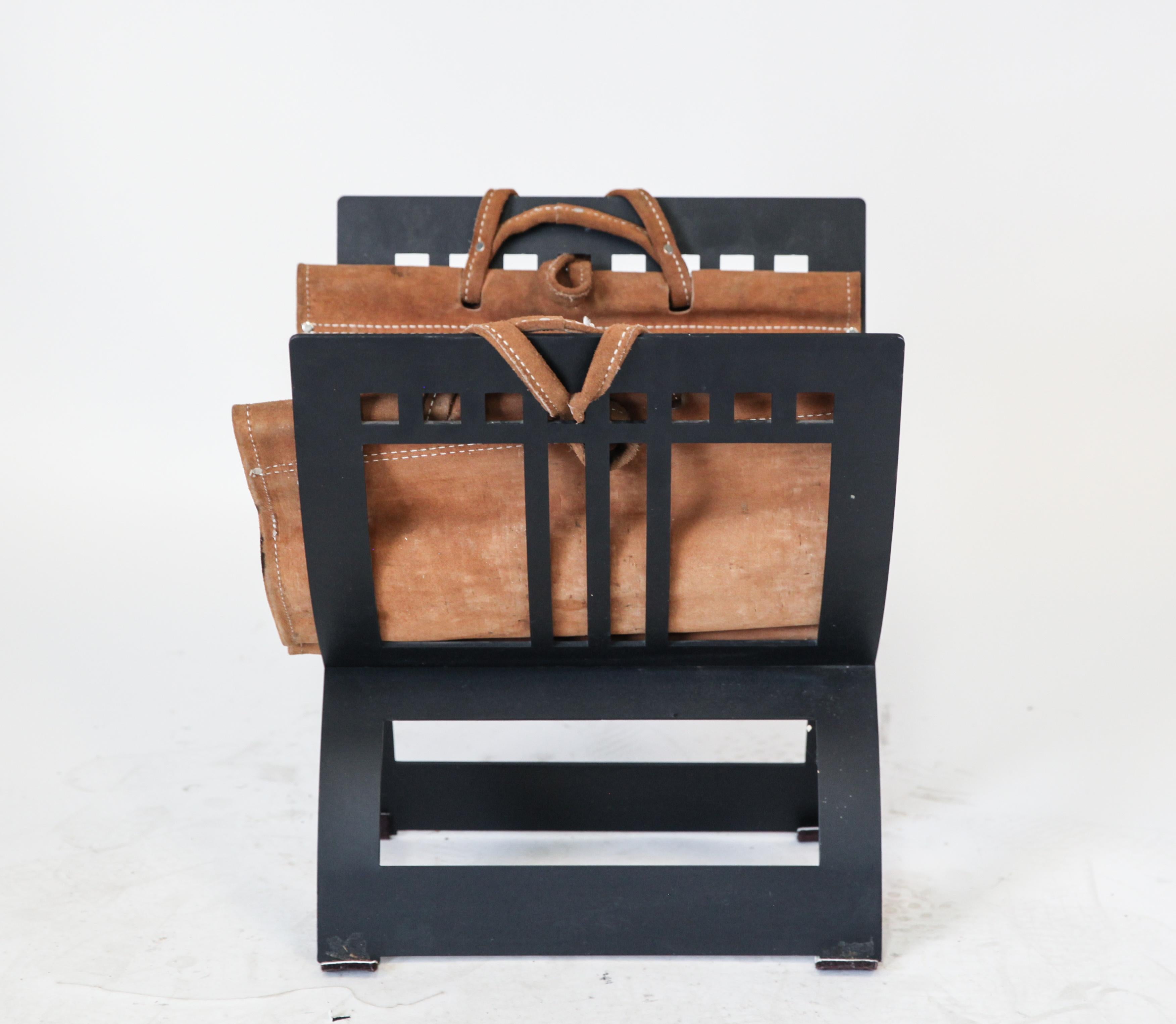 Roman manner steel magazine or newspaper rack in curule form. The piece has a tan hide for holding the magazines and is in great vintage condition with age-appropriate wear and use. Measures: 19.25