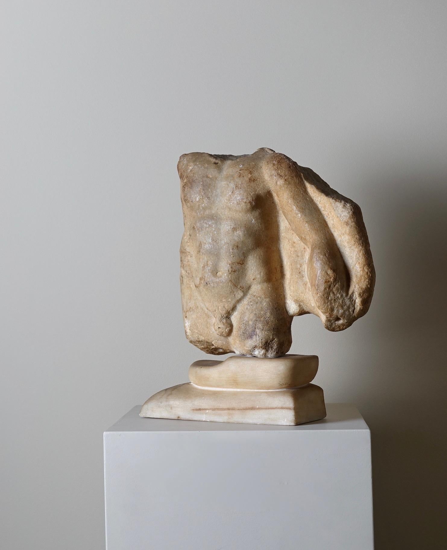 Roman marble torso of a satyr 
2nd century AD
H : 21 cm (without the base)

Provenance : Collection of Monsieur G. (1970) , Paris 

Facing frontally, nude but for a nebris falling from his left shoulder this fine torso depicts a youthful body with