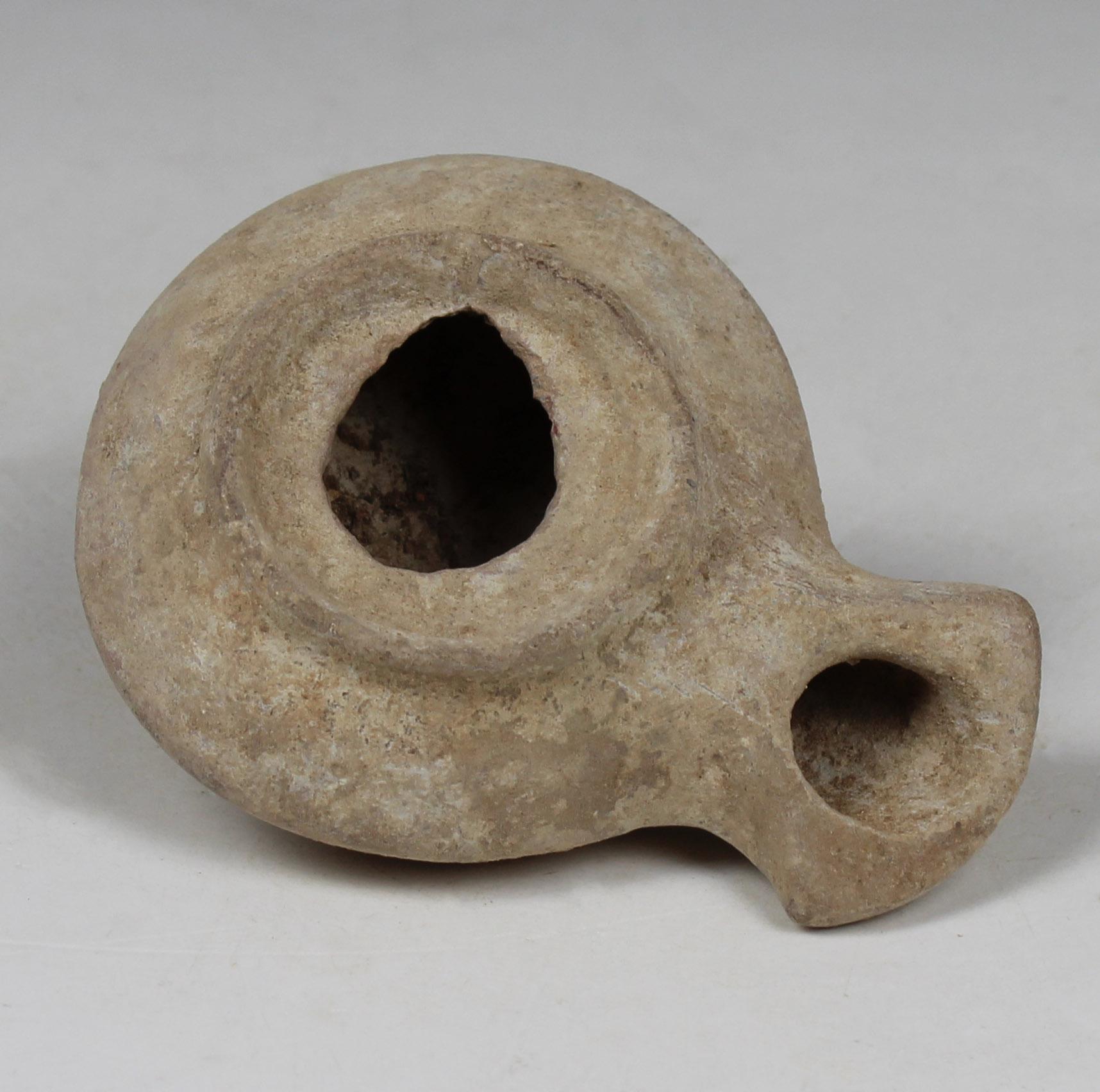 ITEM: Oil lamp, Type ‘Herodian’, Kennedy 3, Hadad 4
MATERIAL: Terracotta
CULTURE: Roman, Judaea
PERIOD: 1st Century B.C – 2nd Century A.D
DIMENSIONS: 25 mm x 62 mm x 82 mm
CONDITION: Good condition
PROVENANCE: Ex Jerusalem private collection,