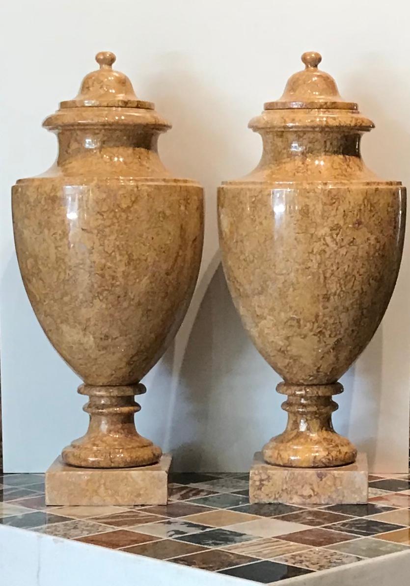 A very beautiful and iconic pair of Italian decorative vases made in neoclassical style with a rare and very precious marble, the broccatello of Spain, carved directly from the block. To confirm the importance and the value of the marble, In the