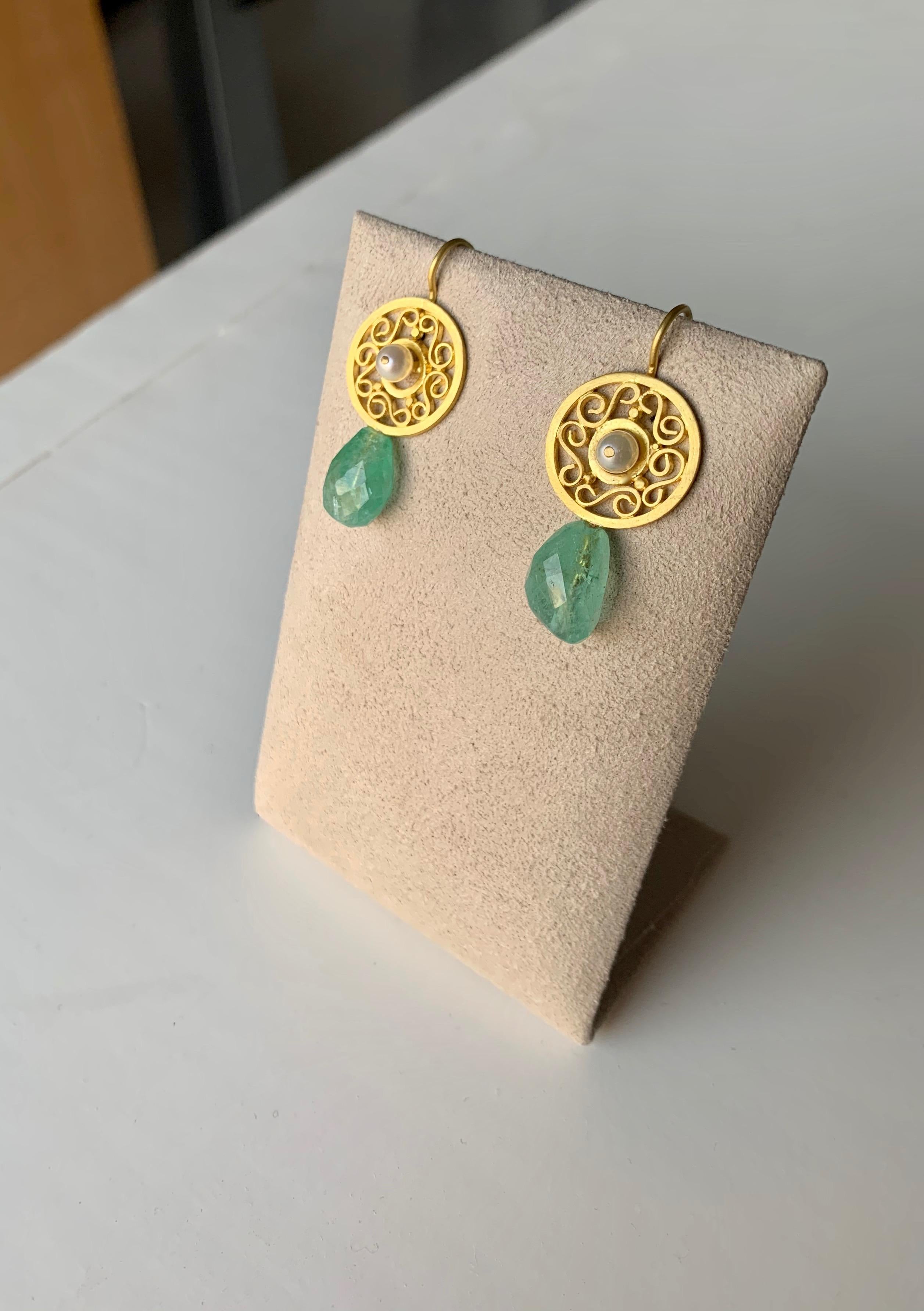 In the style of ancient Roman filigree jewelry, these ornamental earrings are adorned in 22K gold, 20K gold earwire, pearls, and ancient cut emeralds beads 9.45 carats. Entirely made by hand in New York City. 