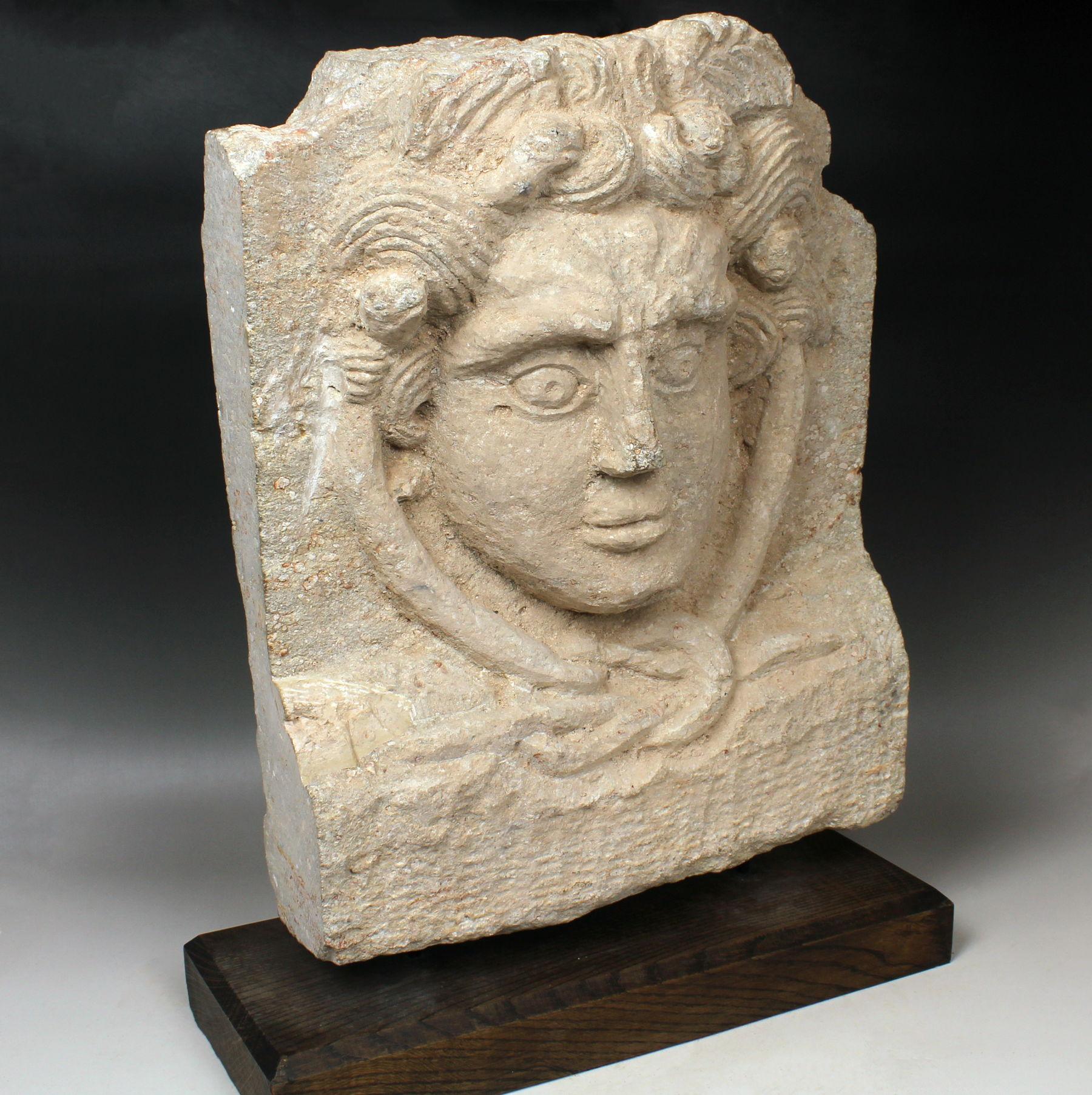 Limestone Roman relief of Medusa and Hercules knot