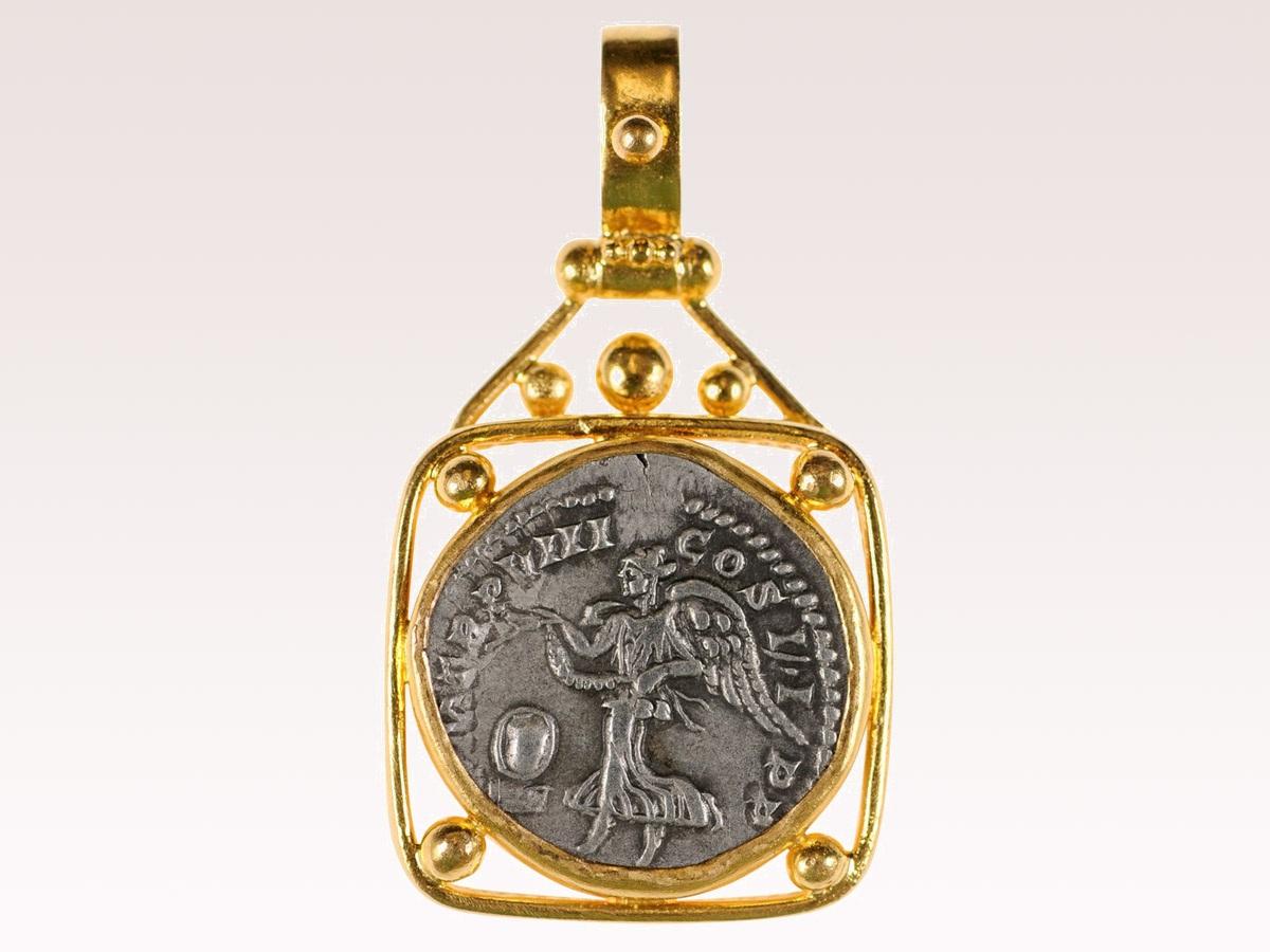 An authentic Roman Imperial, silver Denarius coin (circa 200 AD), set in a custom 22k gold bezel with 22k gold bail. The obverse, or front side of this coin features the laureate head of Septimus Severus (Roman Emperor from 193-211 AD). On the