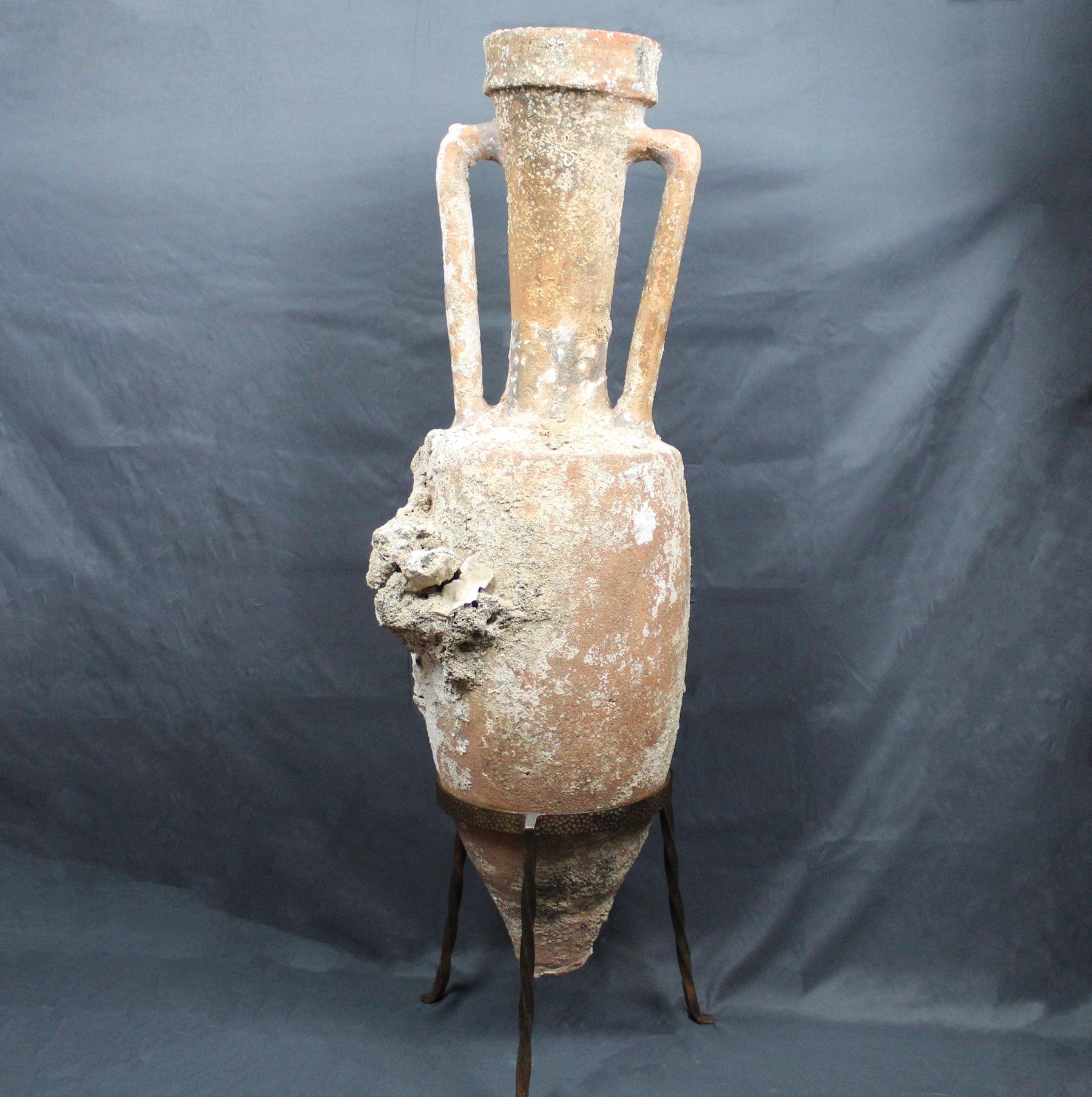 ITEM: Shipwreck amphora, Type Dressel 1B
MATERIAL: Pottery
CULTURE: Roman, Republican period
PERIOD: 2nd – 1st Century B.C
DIMENSIONS: 110 cm x 29 cm (without stand), 117 cm x 29 cm (with stand)
CONDITION: Good condition. Small restorations in the