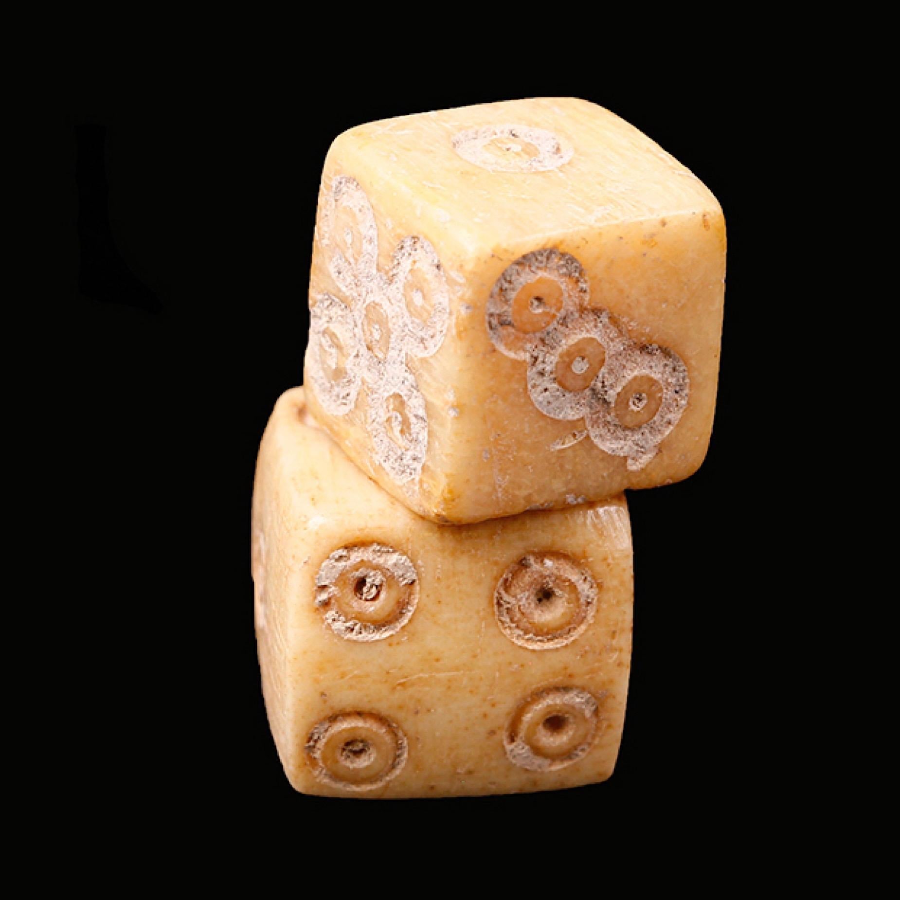 A pair of Roman six-sided modelled dice , known in Latin as tesserae. 

Each side is incised with the appropriate number of circles, which consist of a large outer ring and small central circle,

circa 1st-3rd century AD

Condition: Fine condition