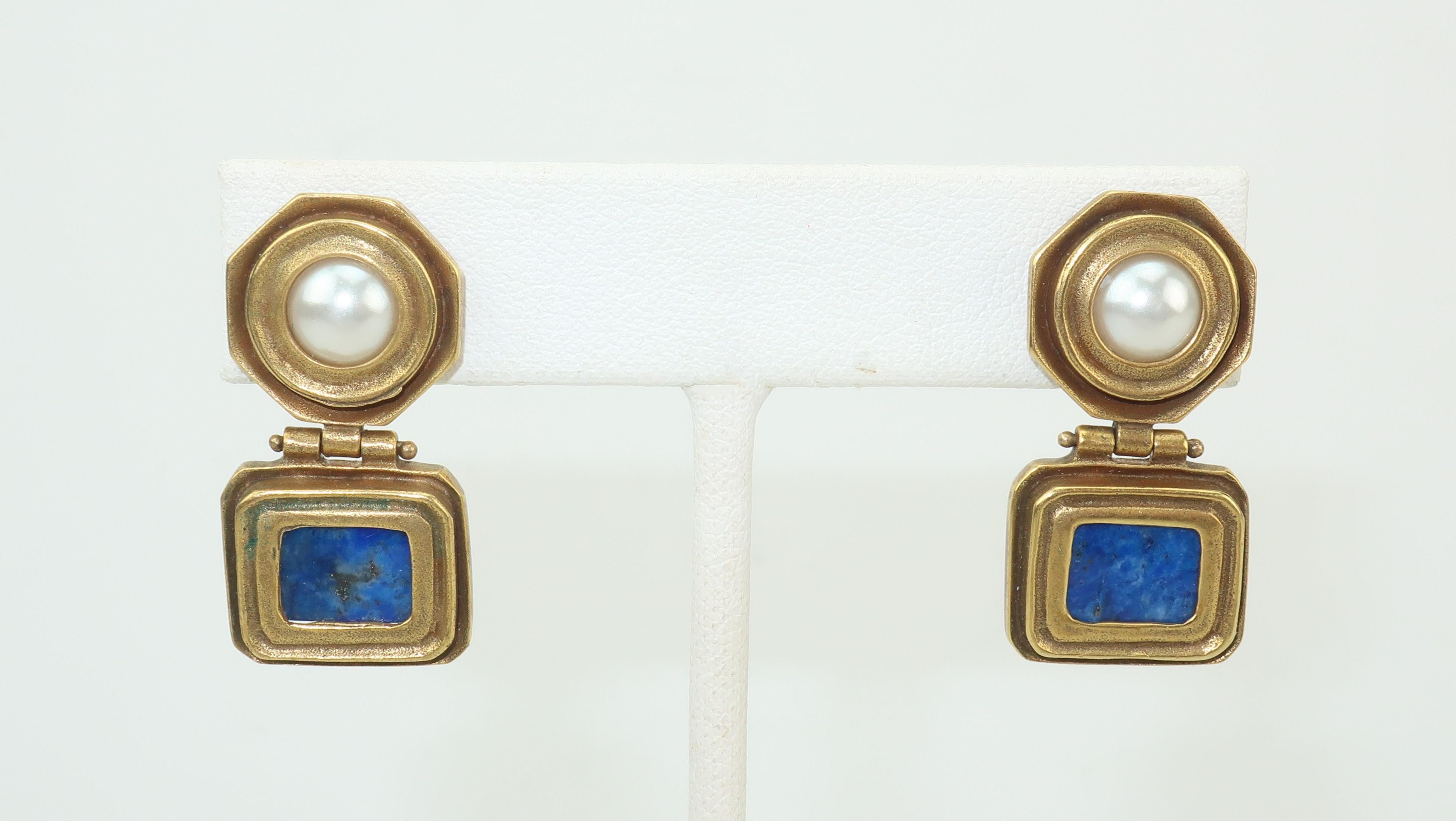 Metropolitan Museum of Art reproduction classical Roman style pierced post earrings fabricated from antiqued brass, faux pearl and lapis lazuli.  The hinged drop provides an articulated movement to the diminutive silhouette.  Each earring measures