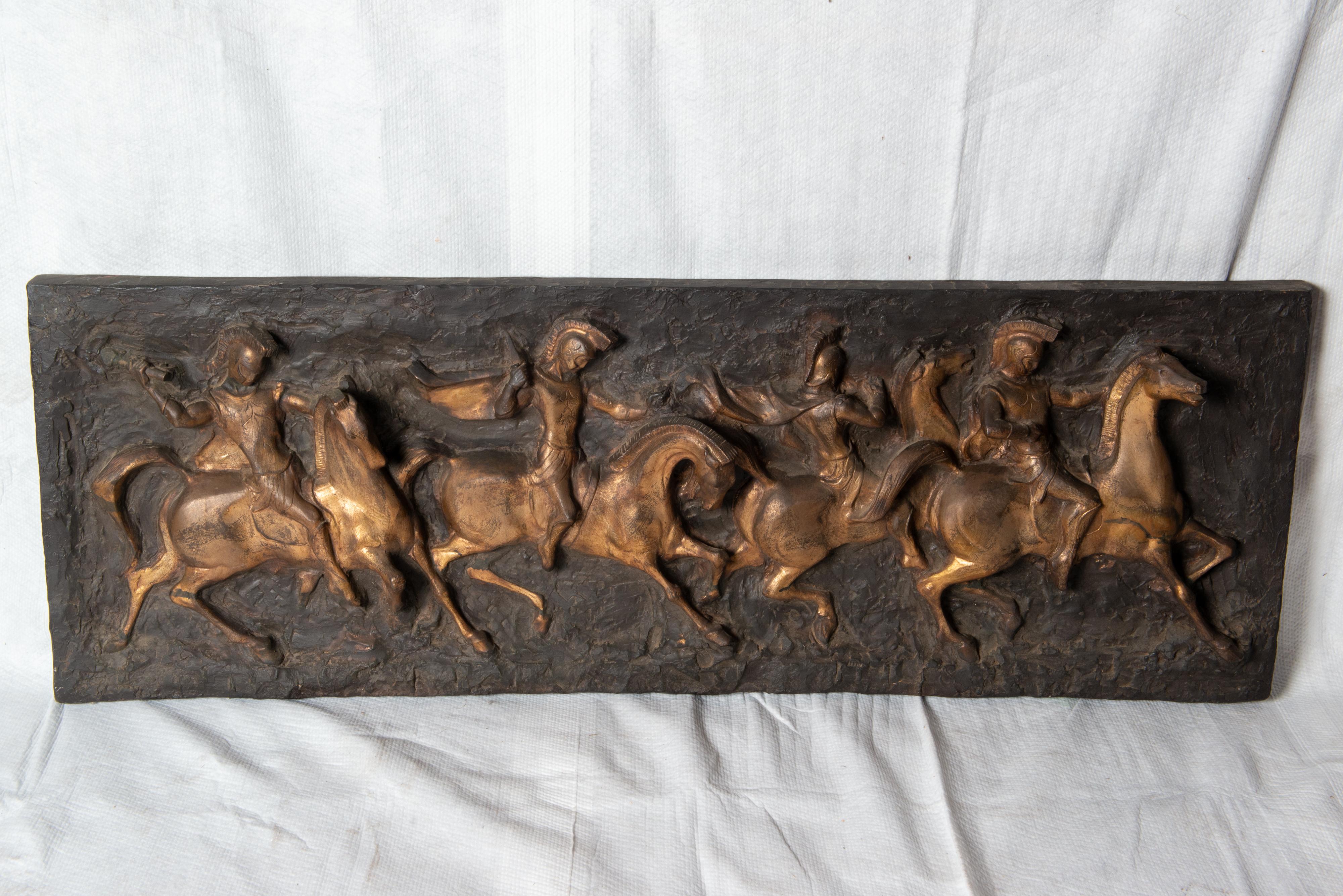 A great decorative Roman Warrior Frieze, with a black background and bronze colored soldiers on horseback in high relief. Made of fiberglass.
A statement piece.