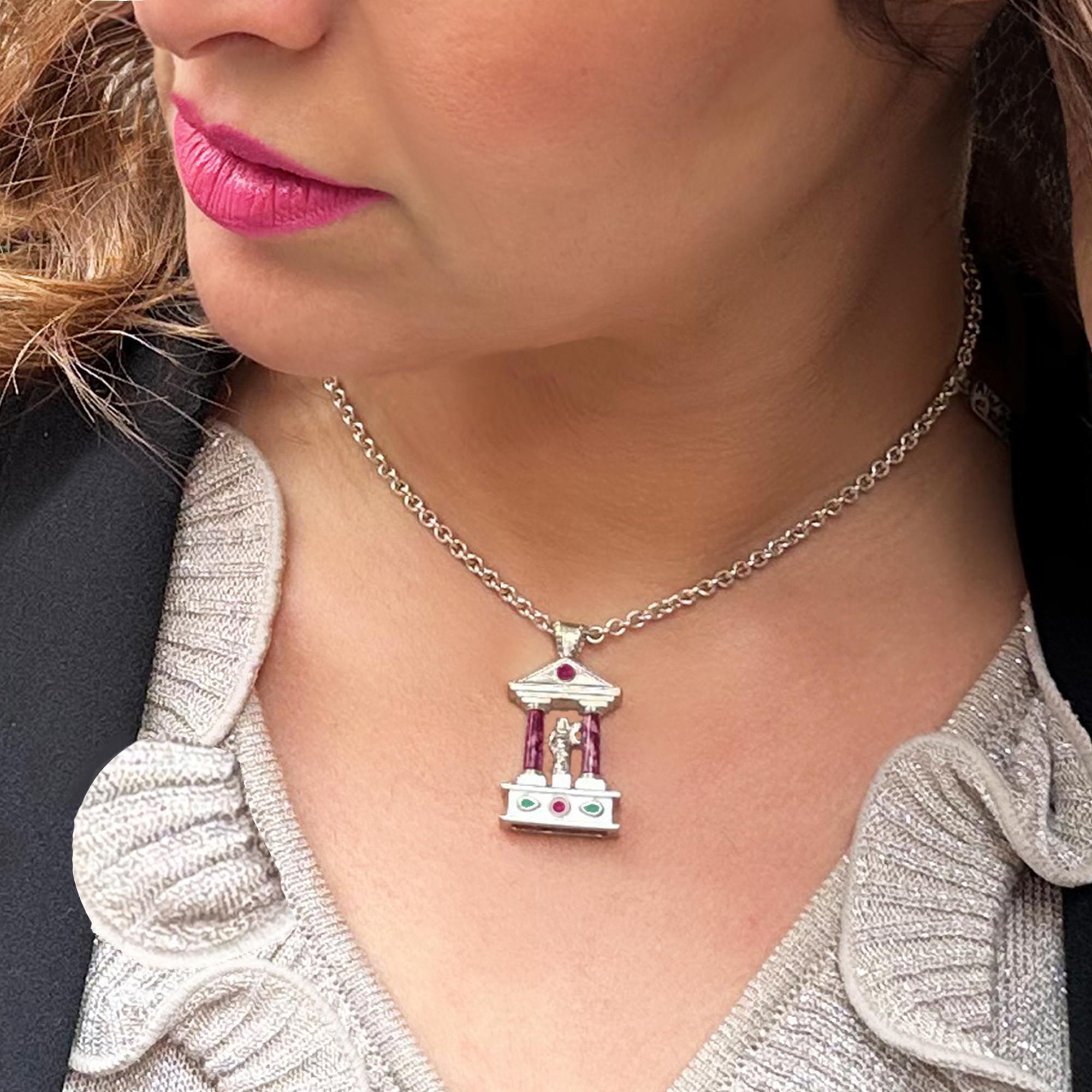 This pendant, in sterling silver, was handcrafted by our goldsmiths, taking inspiration from a Roman temple ! The columns are made with an authentic Imperial marble, red porphyry, and in the central part two rubies and two fragments of green Greek