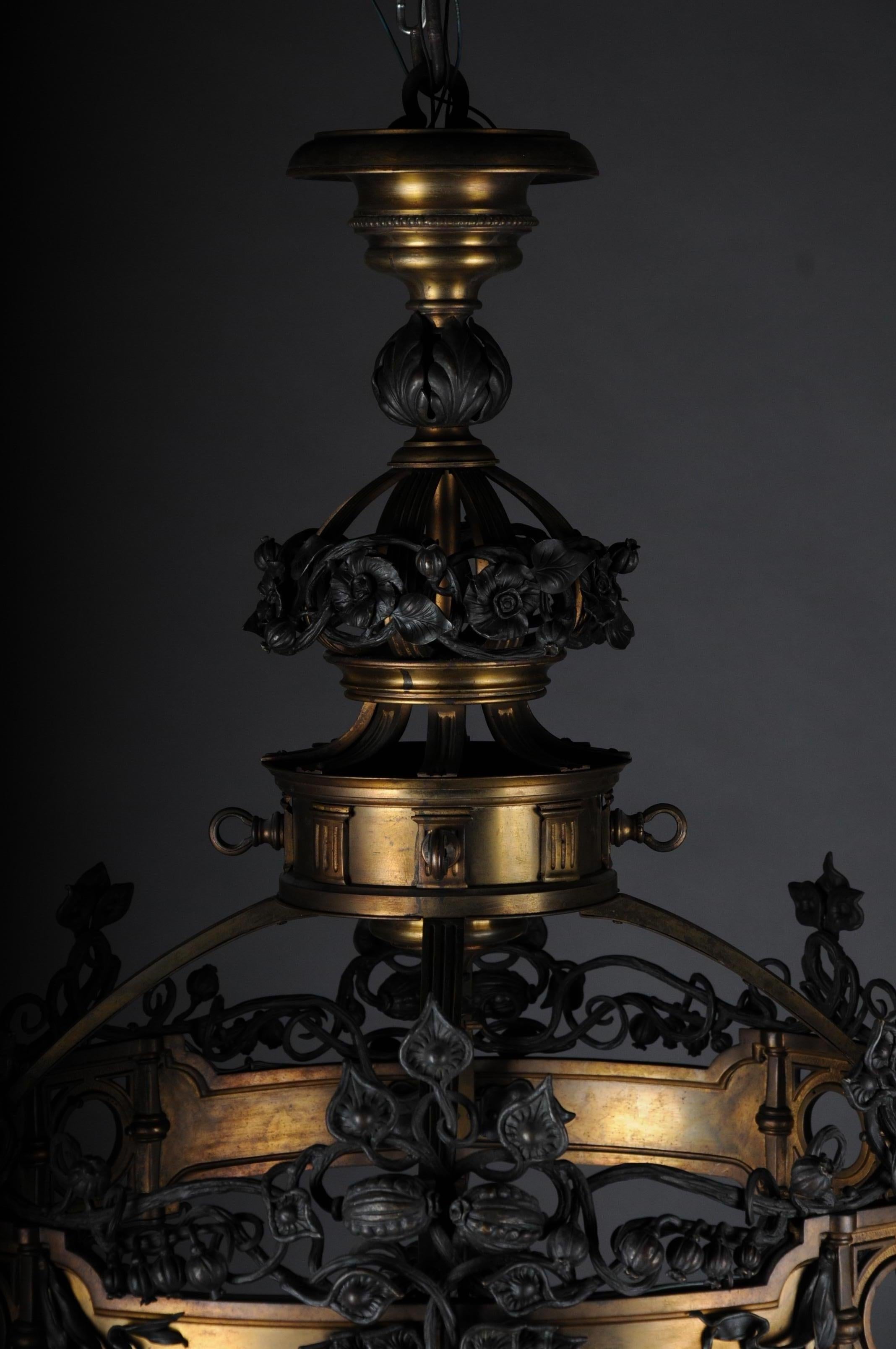 Romanesque Art Nouveau chandelier bronze, France, circa 1900

Extremely unusual chandelier in Art Nouveau / Romanesque design, circa 1900. Multi-sectioned circular body frame made of solid bronze.
In addition, very filigree wrought iron Art