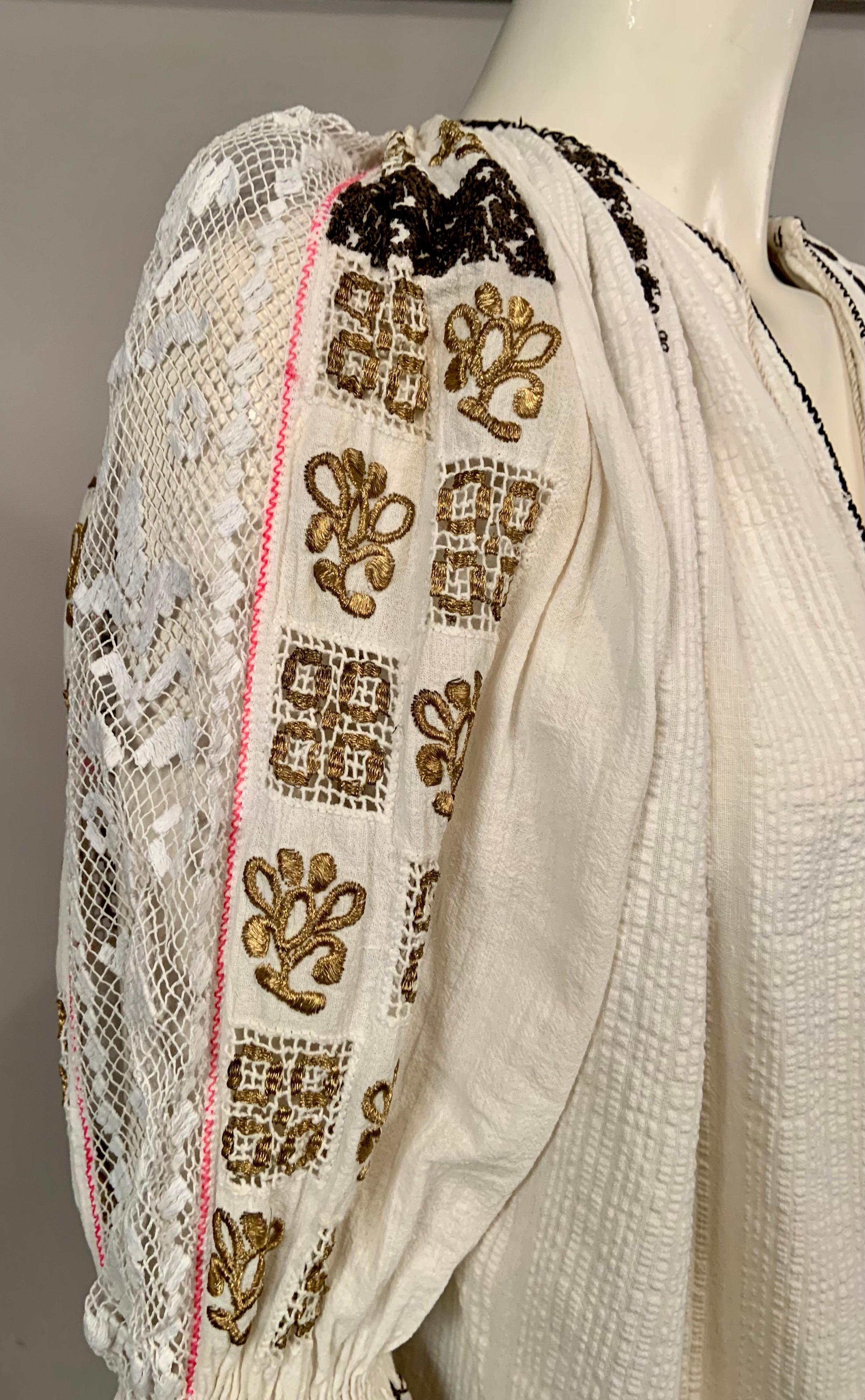 This Romanian blouse is one of the nicest that I have ever owned.  The sophisticated use of  black and metallic gold embroidery and the wide bands of lace on the sleeves and the cuffs are very interesting and beautiful. The blouse is in excellent