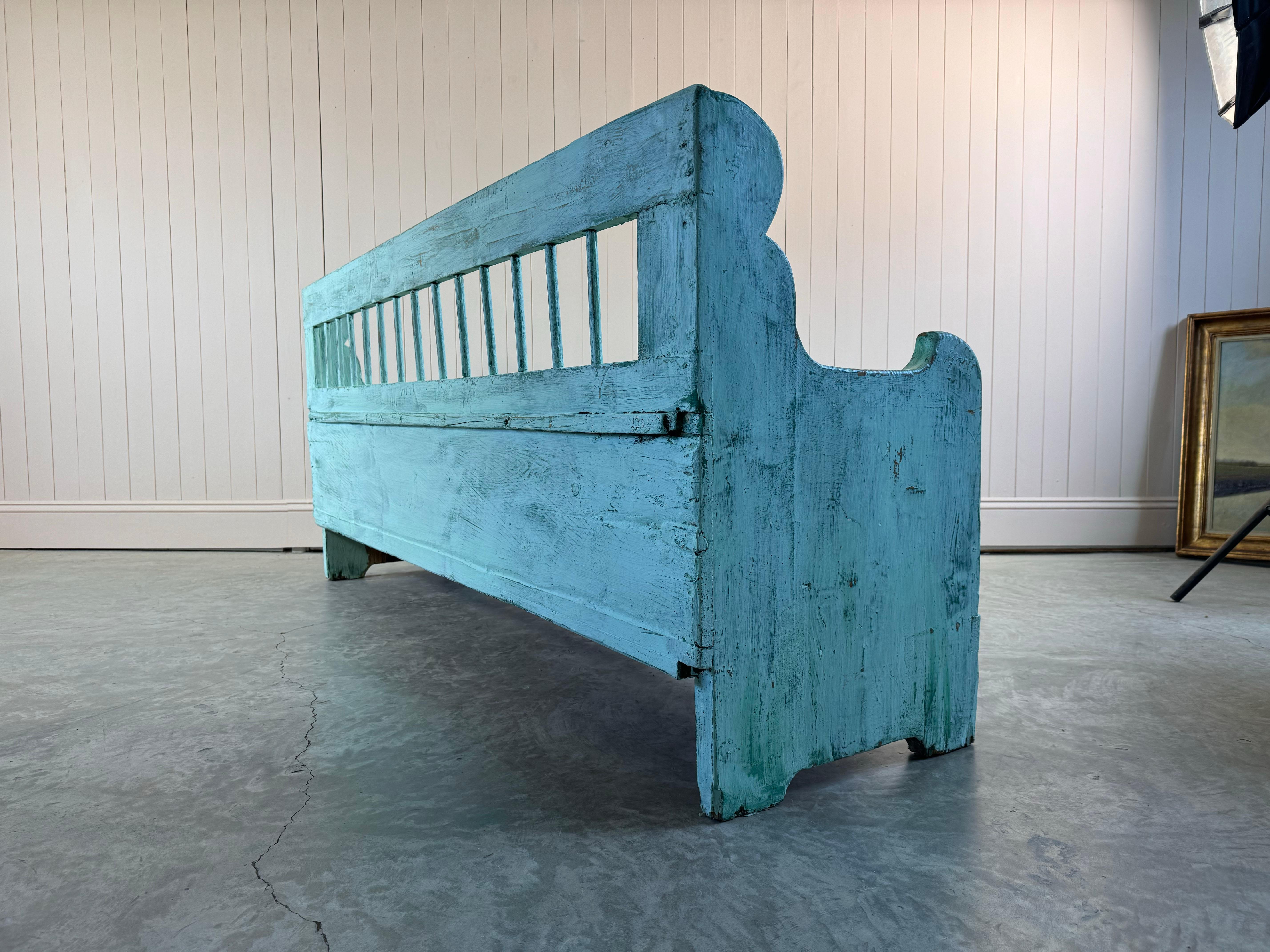 This settle or bench is late 19th Century.  It is a sturdy piece of furniture. It has a fantastic colour. Would look great in a hallway but easily placed anywhere in the house, with the extra bonus of storage space under the seat.

It has been