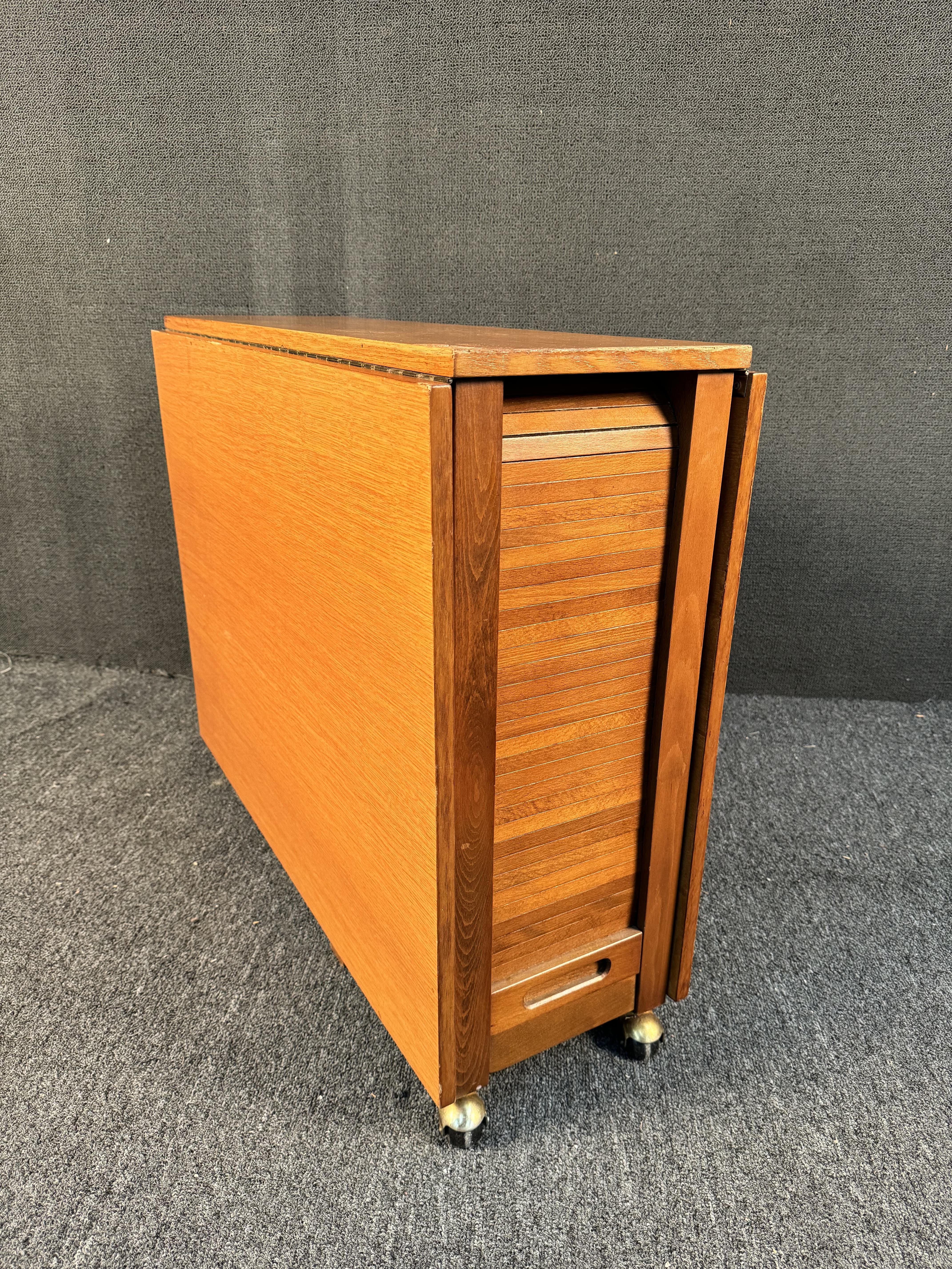 Bring home excellent mid-century Romanian design with this versatile drop leaf trolley dining set! Blending Scandinavian aesthetics with Eastern Bloc practicality, this walnut Bruno Mathsson style drop leaf table expands and perfectly stores a