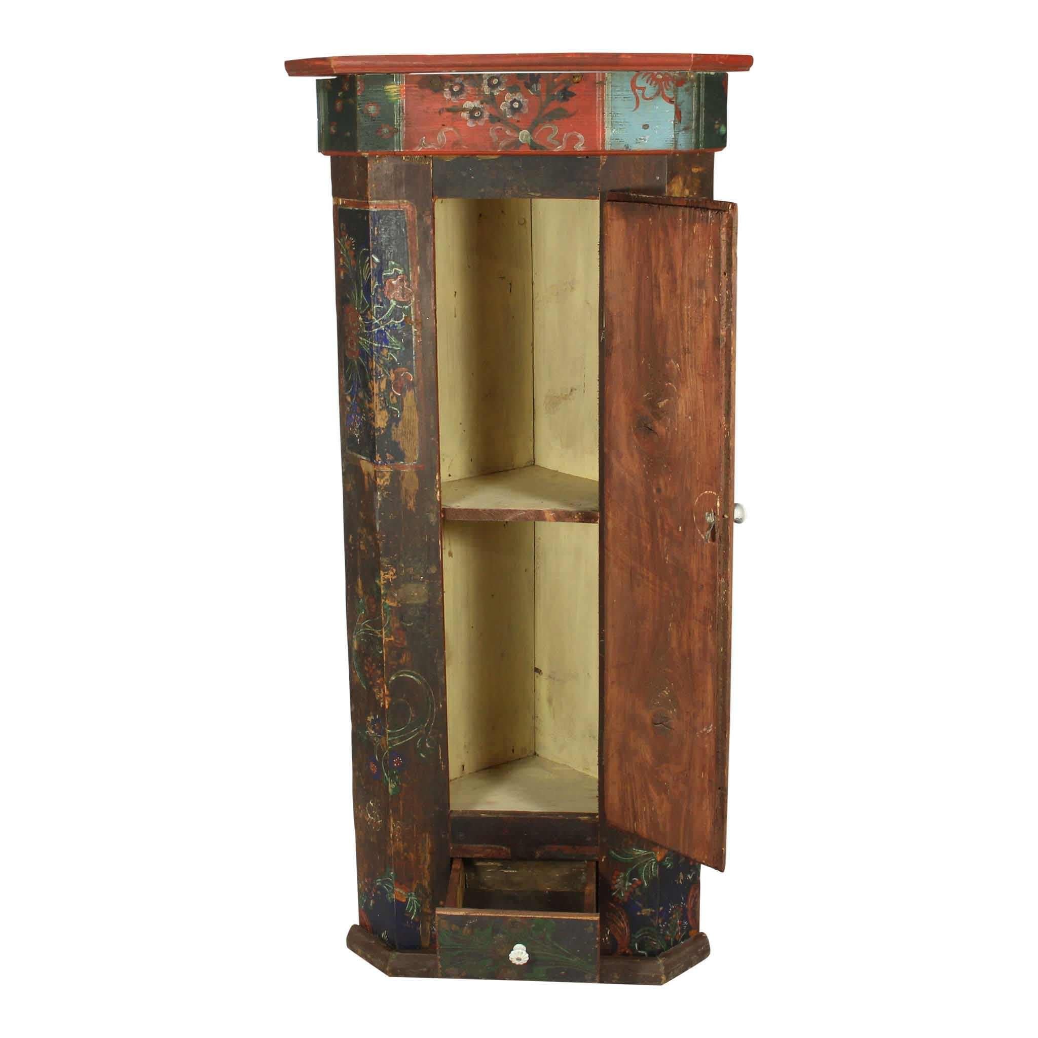 Hand-painted in rich, vibrant colors true to Romanian folk art, this petite corner cabinet showcases a small footprint and triangular shaped back, making it ideal to tuck into even the smallest of corners. The painting, which features a floral motif