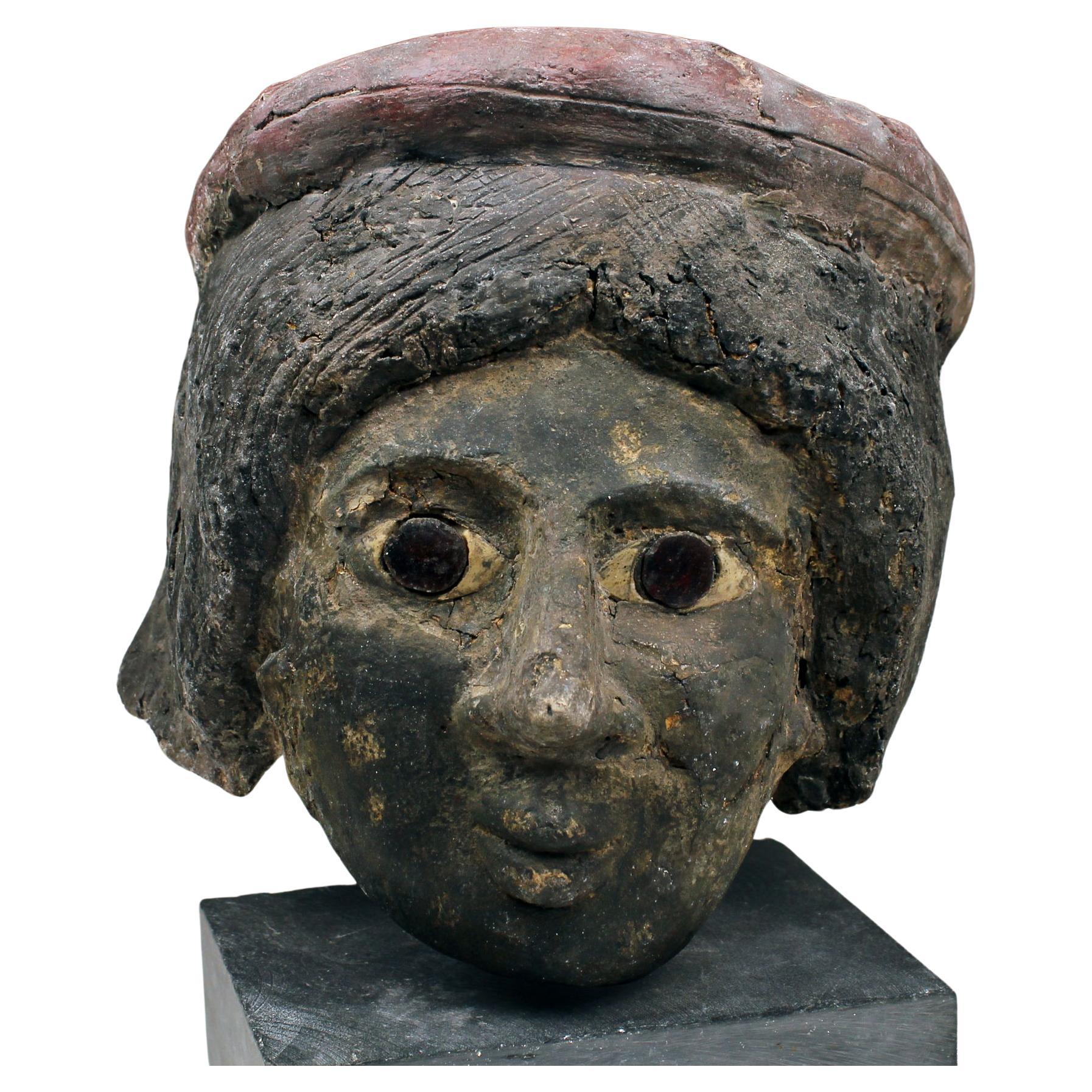 Romano-Egyptian cartonnage mummy mask depicting a female head For Sale
