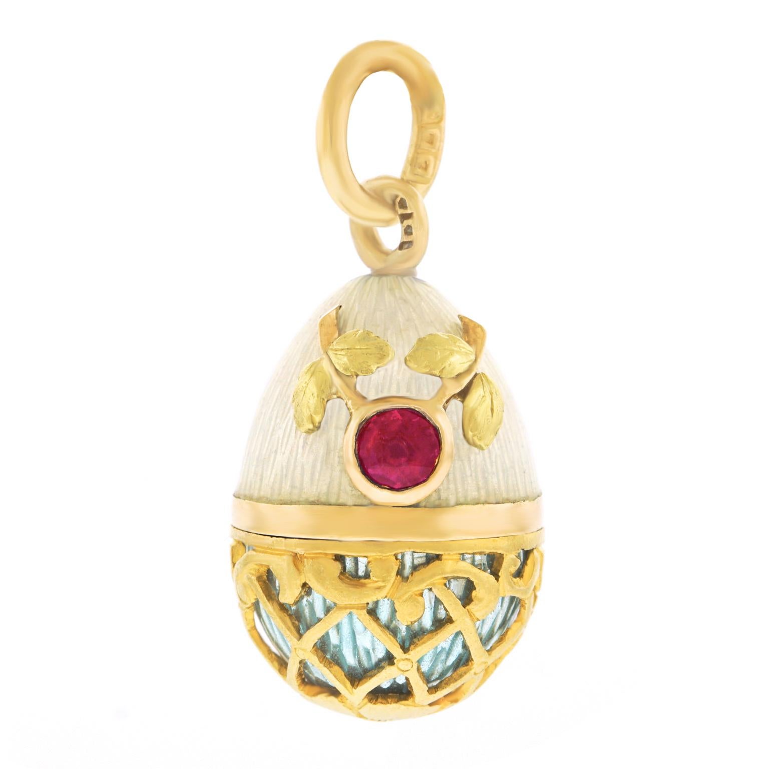 Circa early 1900s, 14k, Russia.  From the ballroom at the Summer Palace to the streets of Paris, Russian Egg Pendants accessorize the chic of every age. This jewel features ruby and enamel with an Art Nouveau gold overlay. Finely made, it is in very