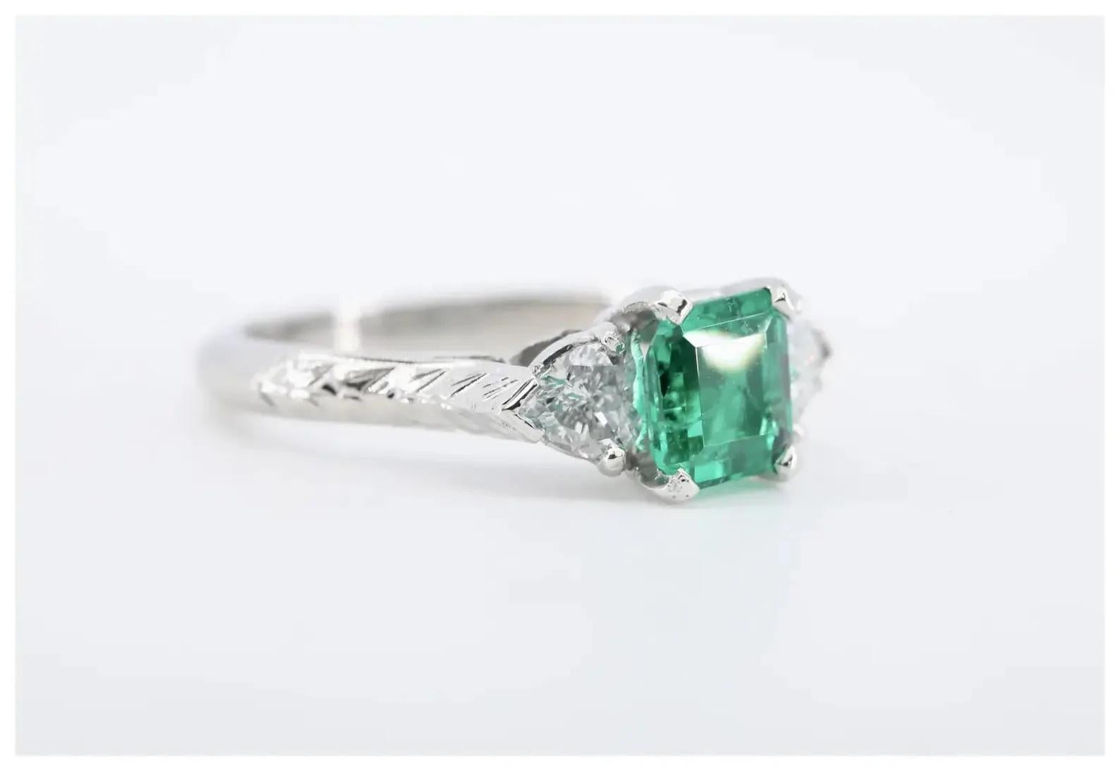 Art Deco Romantic 1.42 CTW Emerald & Heart Shaped Diamond Three Stone Ring, Platinum For Sale