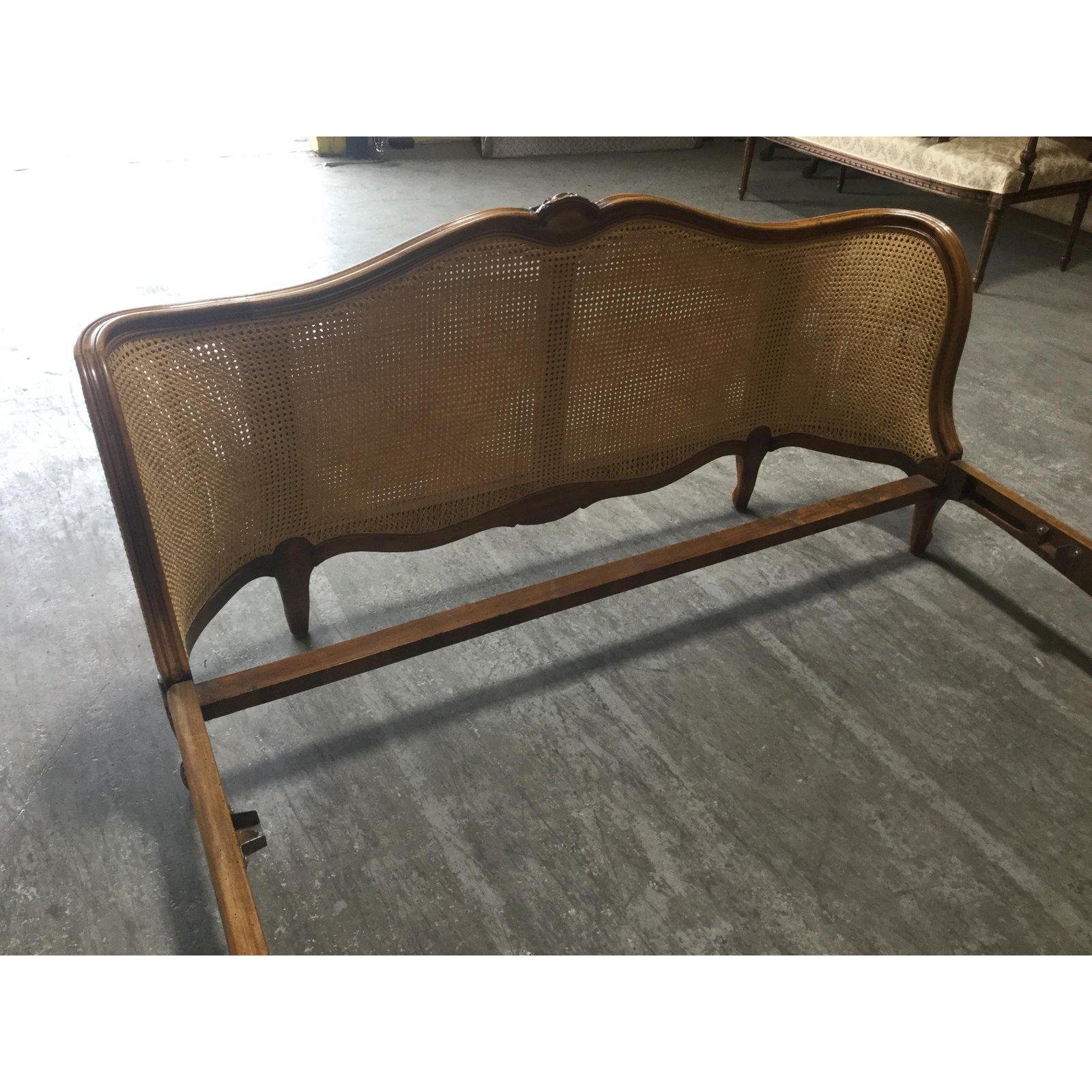Stunning French double-caned Louis XV style bed having full caned headboard and rounded foot board. Caning on the foot board is double -sided. The frame is made of French cherry and features a shell motif at the top. The curved frame of the foot