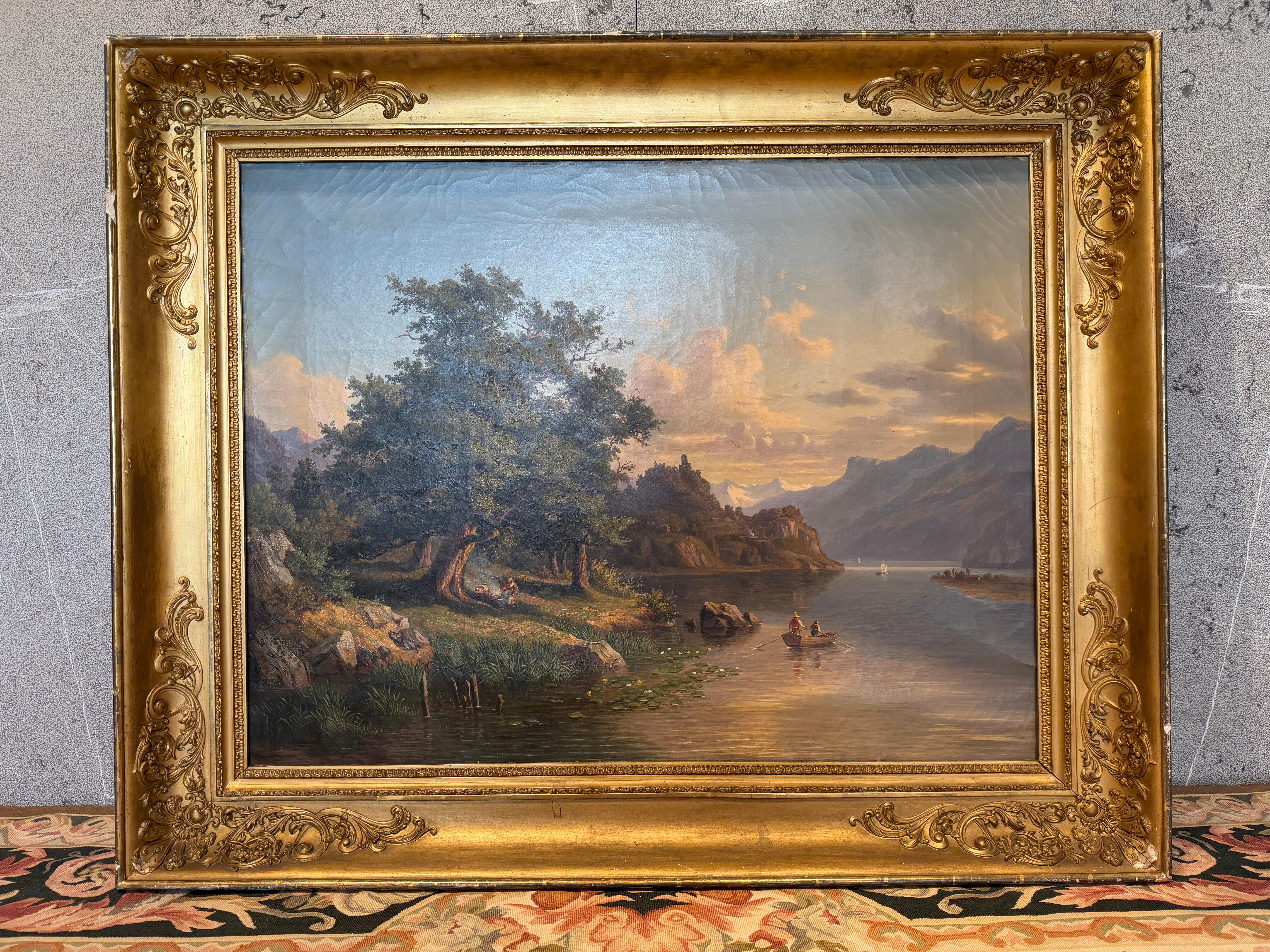 This majestic 19th-century Alpine landscape presents an enchanting view of mountains, water, and idyllic rural life. In the foreground, a serene lakeshore unfolds beneath the shade of an old, sprawling tree, where two figures rest peacefully. A