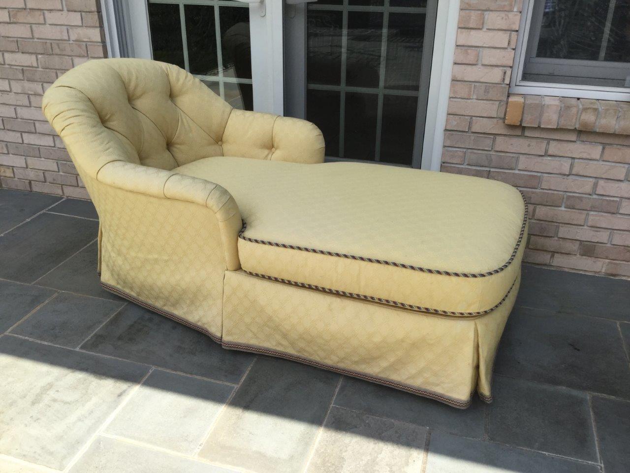 Romantic soft yellow upholstered chaise beautifully tufted with a flat skirt and an accent gimp. Upholstery is heavy weight cotton with a subtle diamond pattern in the fabric. The entire piece is custom-made of quality materials. The cushion is firm