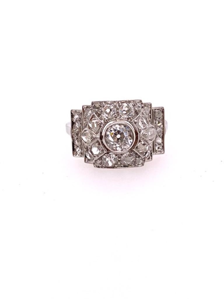 Luminous romantic diamond ring in an unusual horizontal configuration.  Bright rose-cut diamonds with beaded border, leading to the center old mine-cut diamond, approximately .50 ct., in a bezel setting.  Set in platinum.  Size 6 1/4 and can be