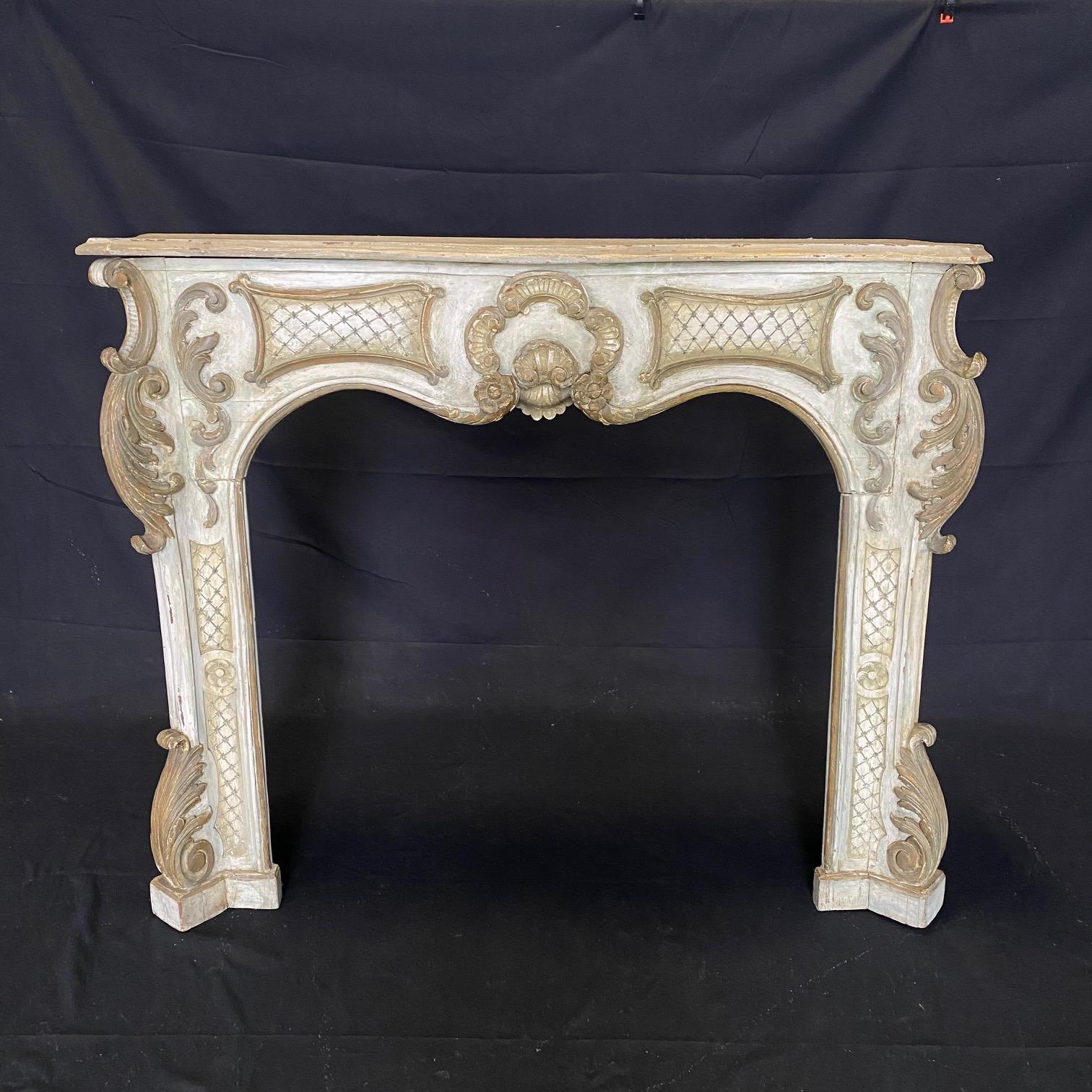 A gorgeous fireplace mantel having serpentine shelf and frieze which is centered with a shell flanked by diamond-patterned background. The jambs are adorned with acanthus leaves and floral drapery down to the bases. A finely carved romantic piece