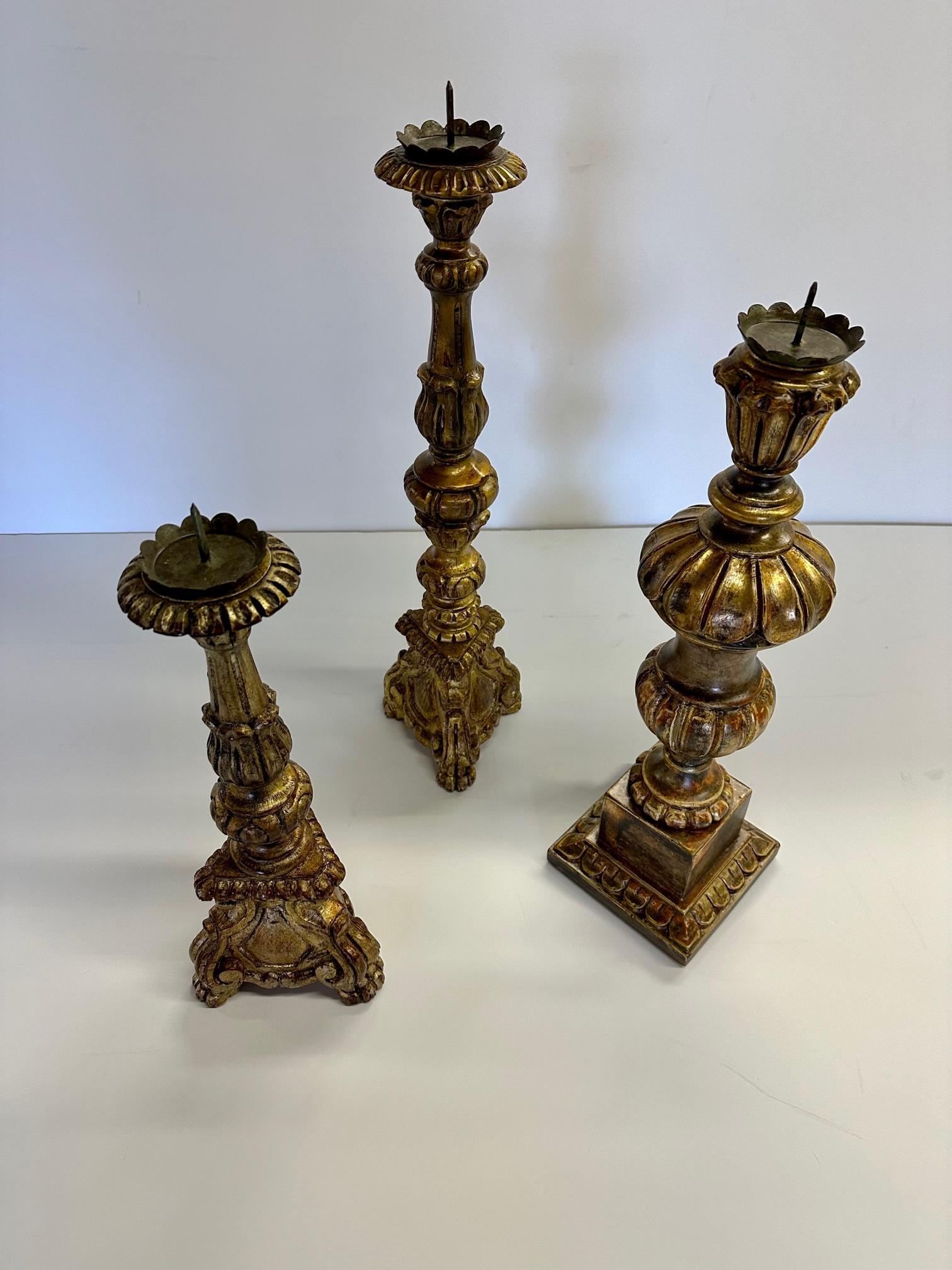 Romantic collection of 3 vintage carved wood and metal gilded candlesticks.
3 sizes are: 6.5 base 23.5 H
 6.5 base 25 H
6.75 base 20 H.