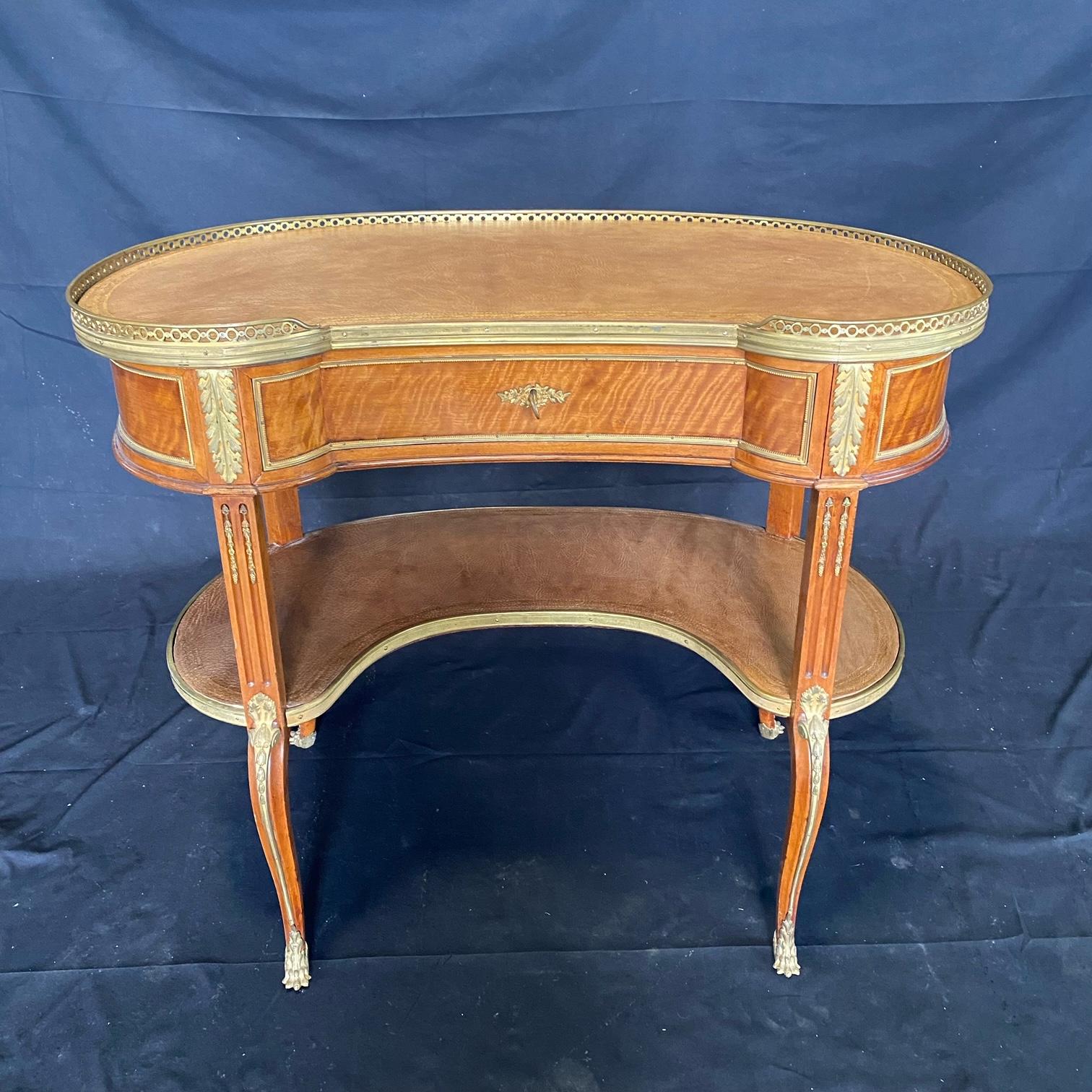 A very fine French Louis XV style 19th C kidney shaped desk with original tooled leather surface, elegantly mounted in fine gilt bronze and on cabriole legs. Faint circle mark on surface (see photos)

#5173.