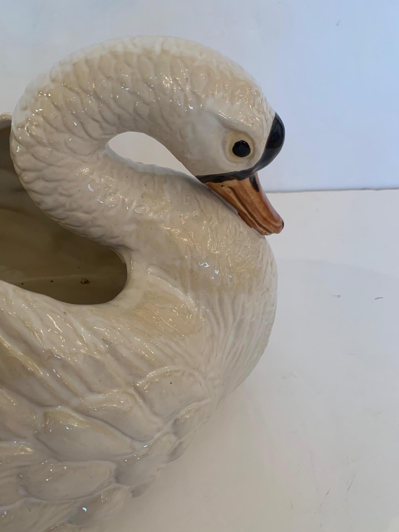 Wonderful large detailed glazed terracotta swan planter that makes a striking centerpiece of tabletop accessory.