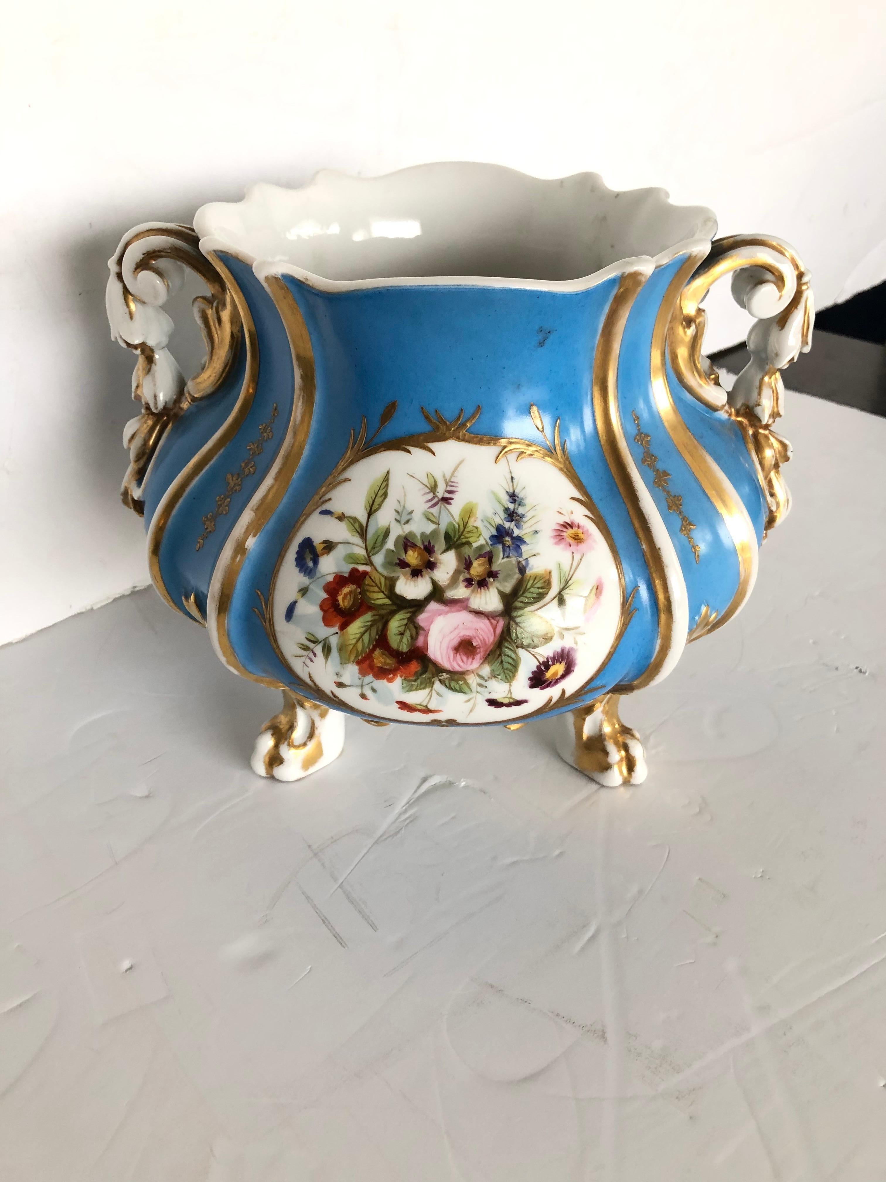 Collectible Old Paris porcelain bowl or vase having marvelous turquoise color, real gold leaf adornment and hand painted meticulous renderings of figures and flowers. Scrolly handles and gestural feet are lovely touches.