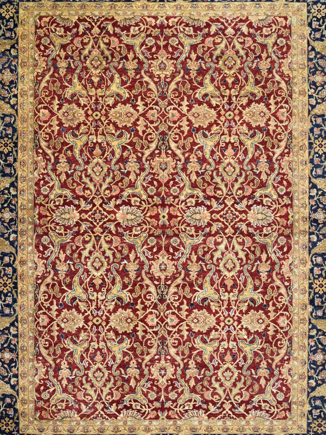 Are you looking for the perfect formal carpet for your Tudor, Victorian, or Colonial-styled home? Look no further than this Lavar carpet, measuring 6’1” x 8’10” and hand-knotted in red, taupe, indigo, gold, and pink wool. Woven in India, this carpet
