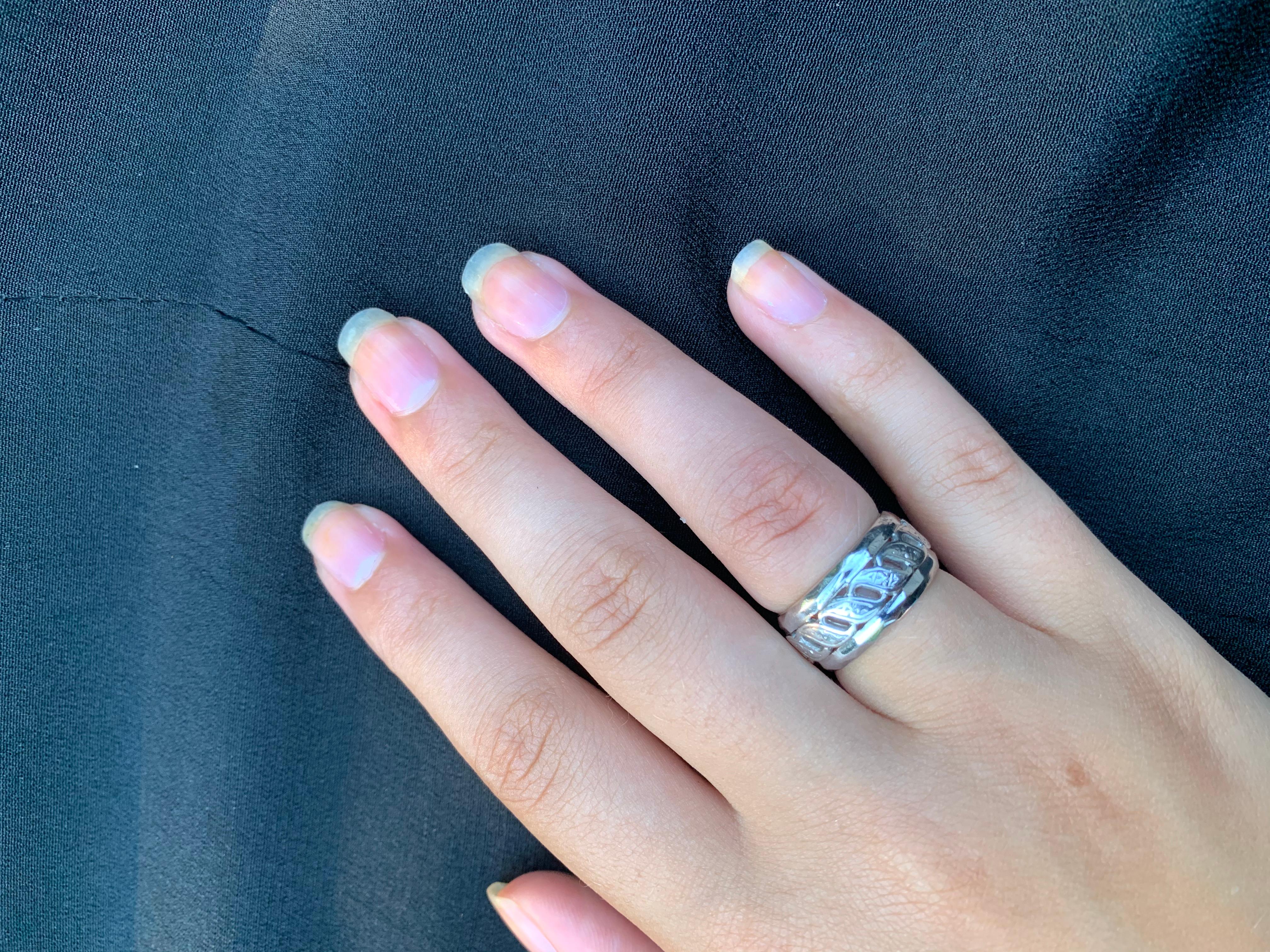 Fine estate reticulated 14K white gold substantial wide band ring
Early 20th Century
Beautifully crafted, unusual, reticulated, heavy 14K white gold band ring composed of stylized S scrolls within a double band border. Each of the S-scrolls features