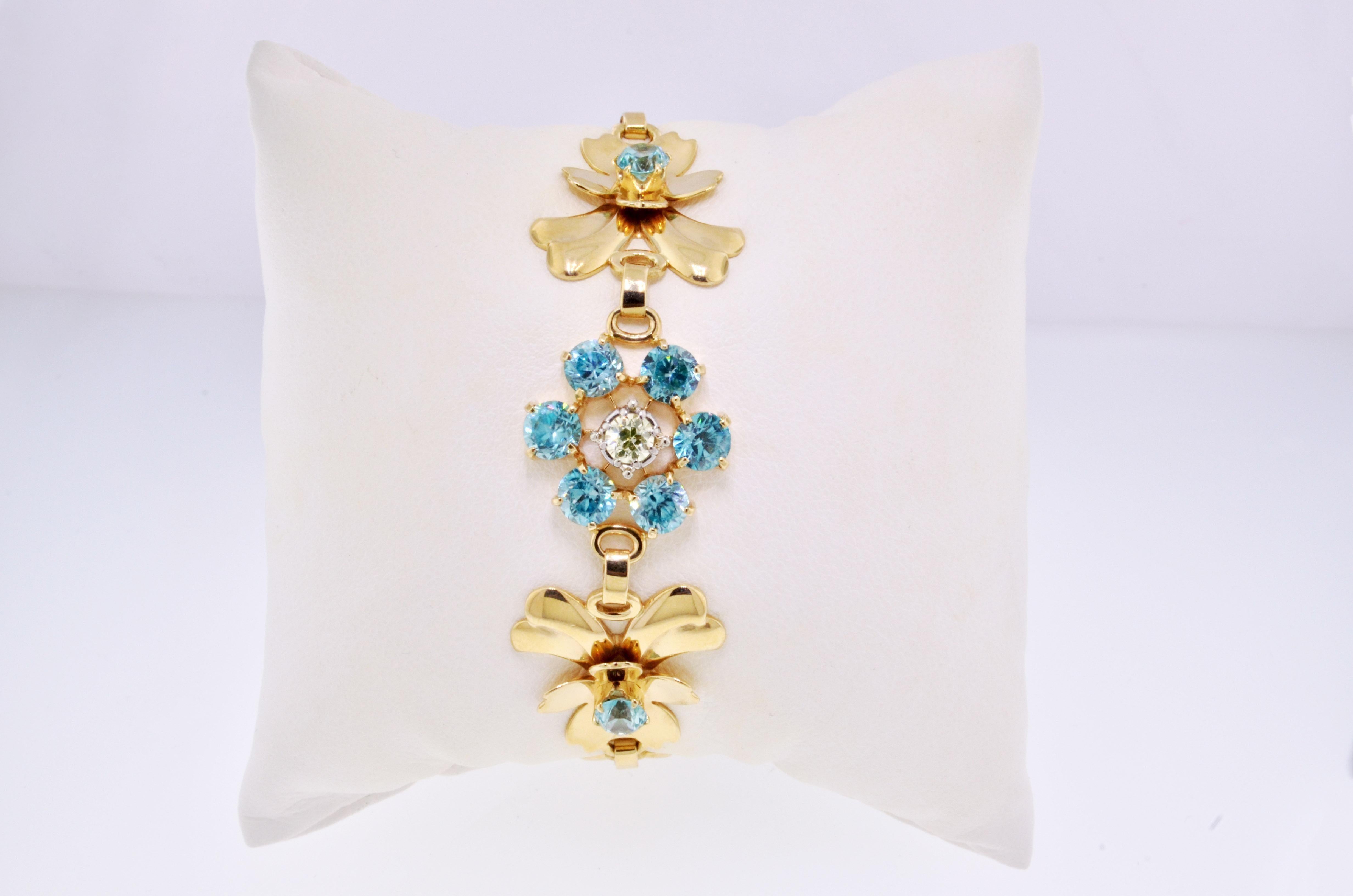 Breathtaking flower bracelet featuring bright blue topaz stones and a sparkling diamond accent. This absolutely gorgeous bracelet has a bold yet romantic design with its lifelike flowers and vibrant colorful gemstones. This botanical beauty makes a