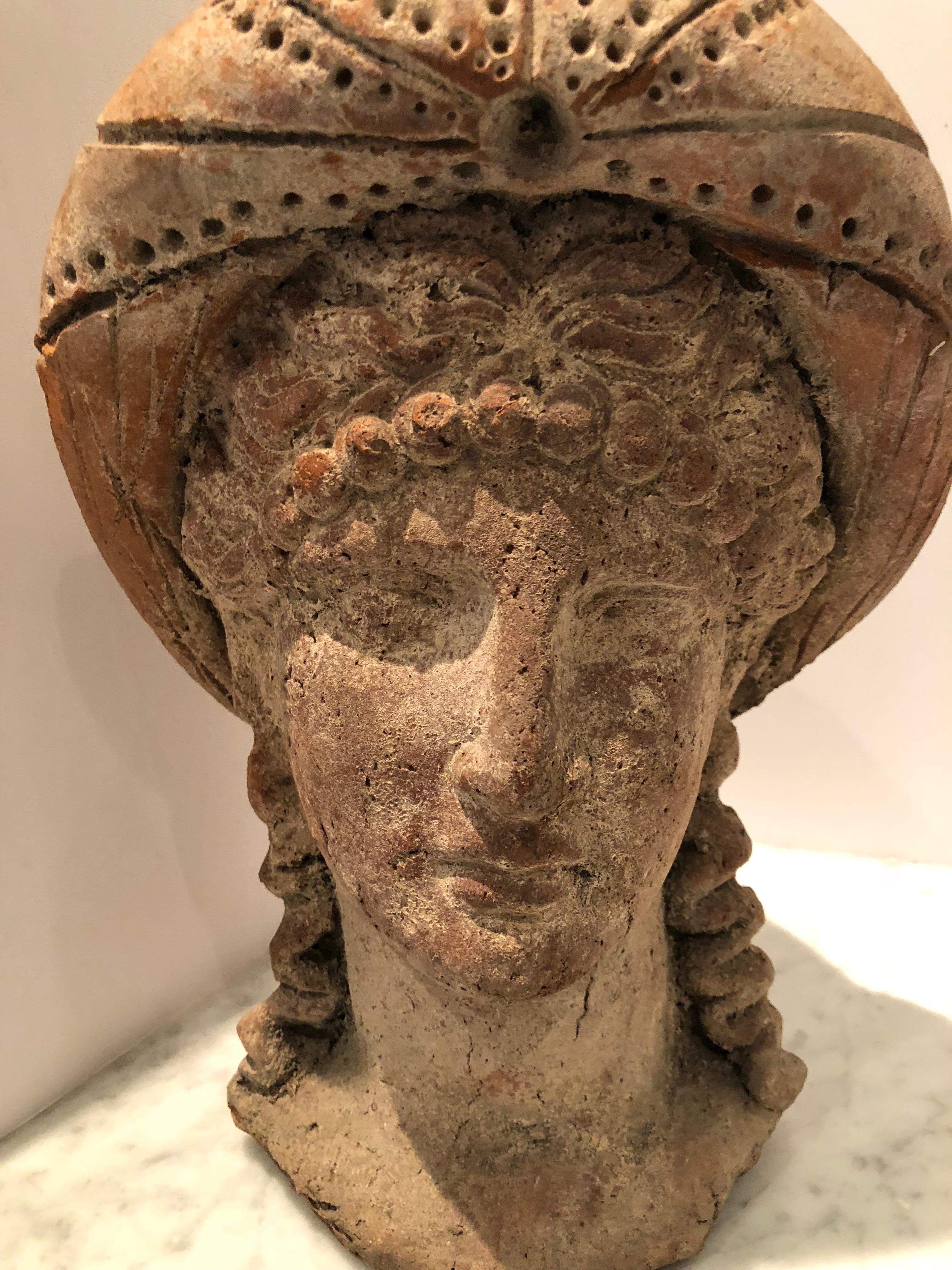 Beautiful Etruscan style head of a youthful girl. The sculpture is hollow, having thick walls. The girl is depicted with long hair wearing an elaborate head dress. Dates to just after the Grand Tour. Acquired from a private collection.