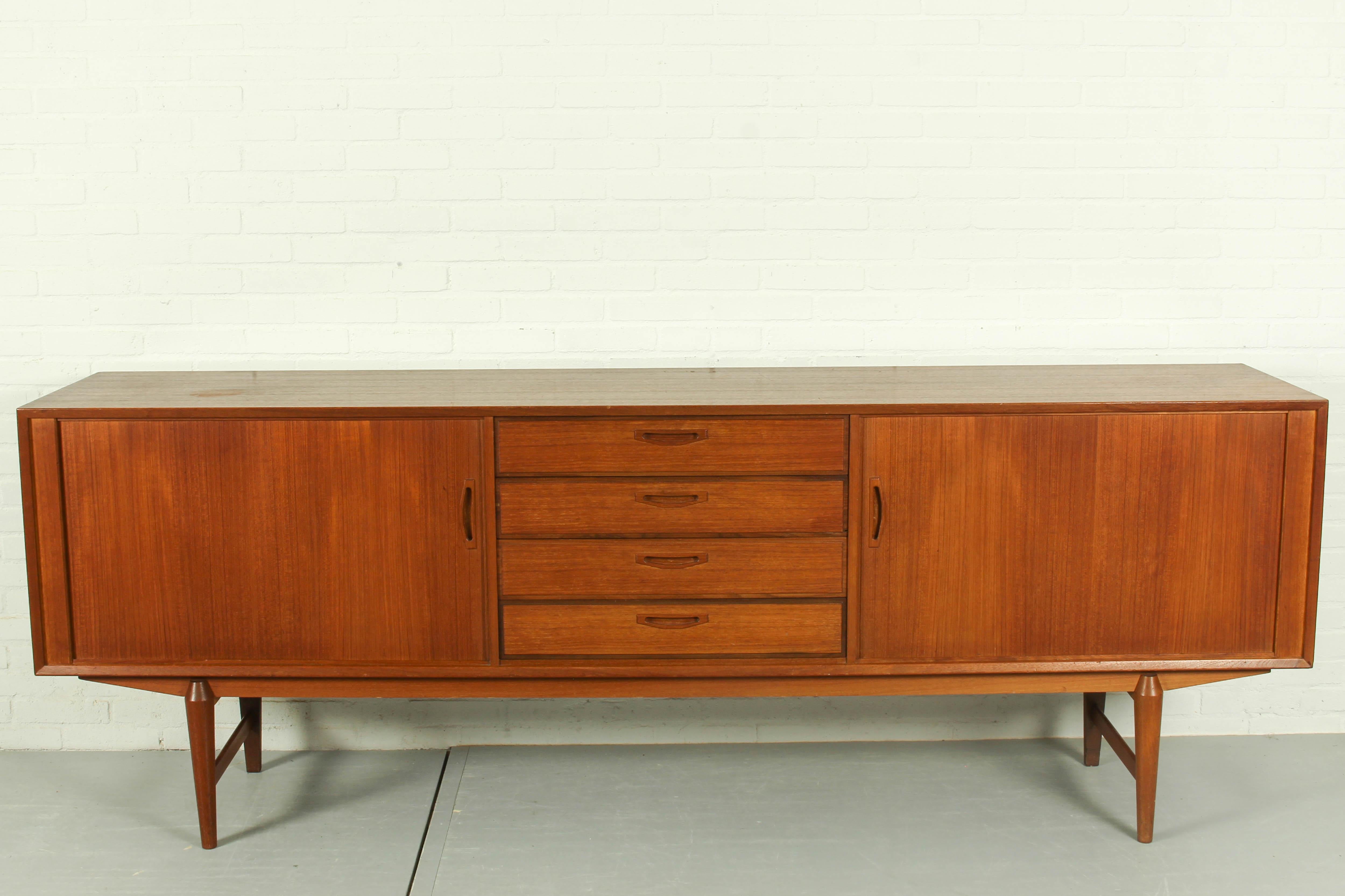 Rare teak sideboard by Omer Lefevre for OMF. The cabinet has four drawers and two beautiful tambour doors. Built to a high standard. In very good condition with traces of use in accordance with age. 

Dimensions: 240cm, 86cm h, 47cm d.
