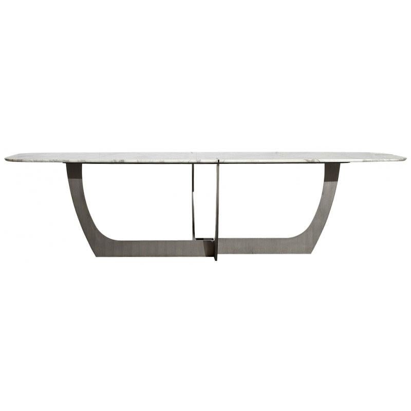 The Romeo dining table designed by Roberto Lazzeroni for Baxter features an oblong Gold Calcatta Marble top with burnished steel inserts. The dining table sits on a steel base with a burnished finish.