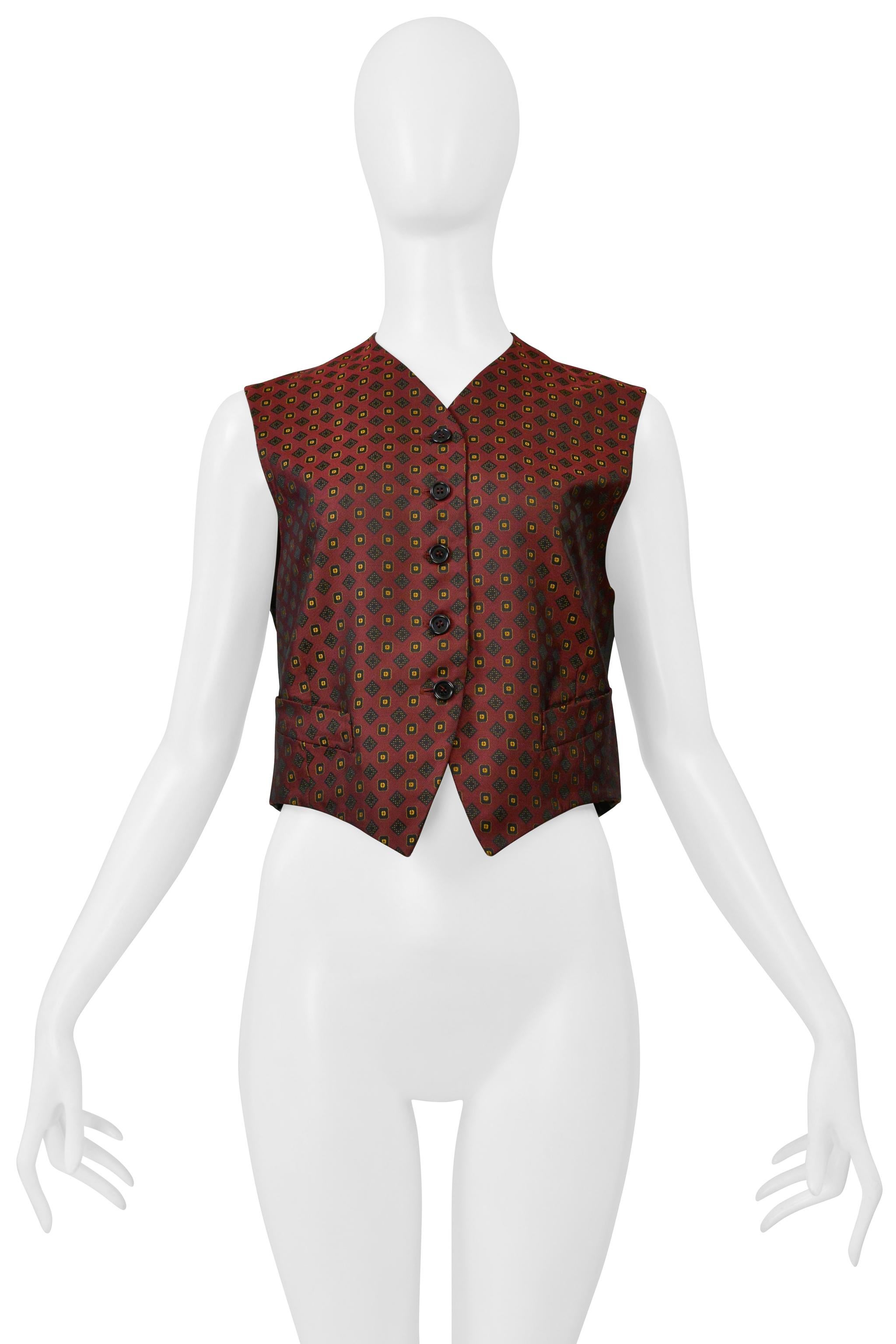 Resurrection Vintage is excited to present a vintage Romeo Gigli burgundy cropped vest from 1986, featuring front button closures, geometric print at the front, ties at the back hem, sleeveless, and front slit pockets. 

Romeo Gigli
Talla: