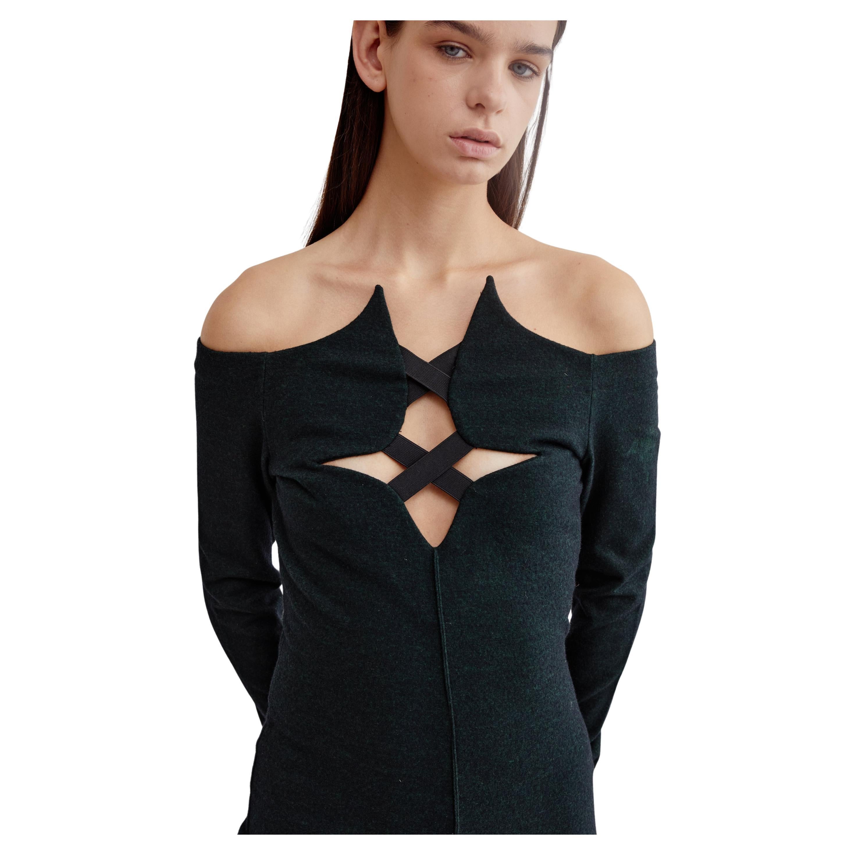 Dating to the F/W 1991 collection, this stunning dress by Italian design darling Romeo Gigli is made from a stretch felted wool blend in a marbled green & grey tone. An off the shoulder style, it features a unique shaped neckline with elastic strap