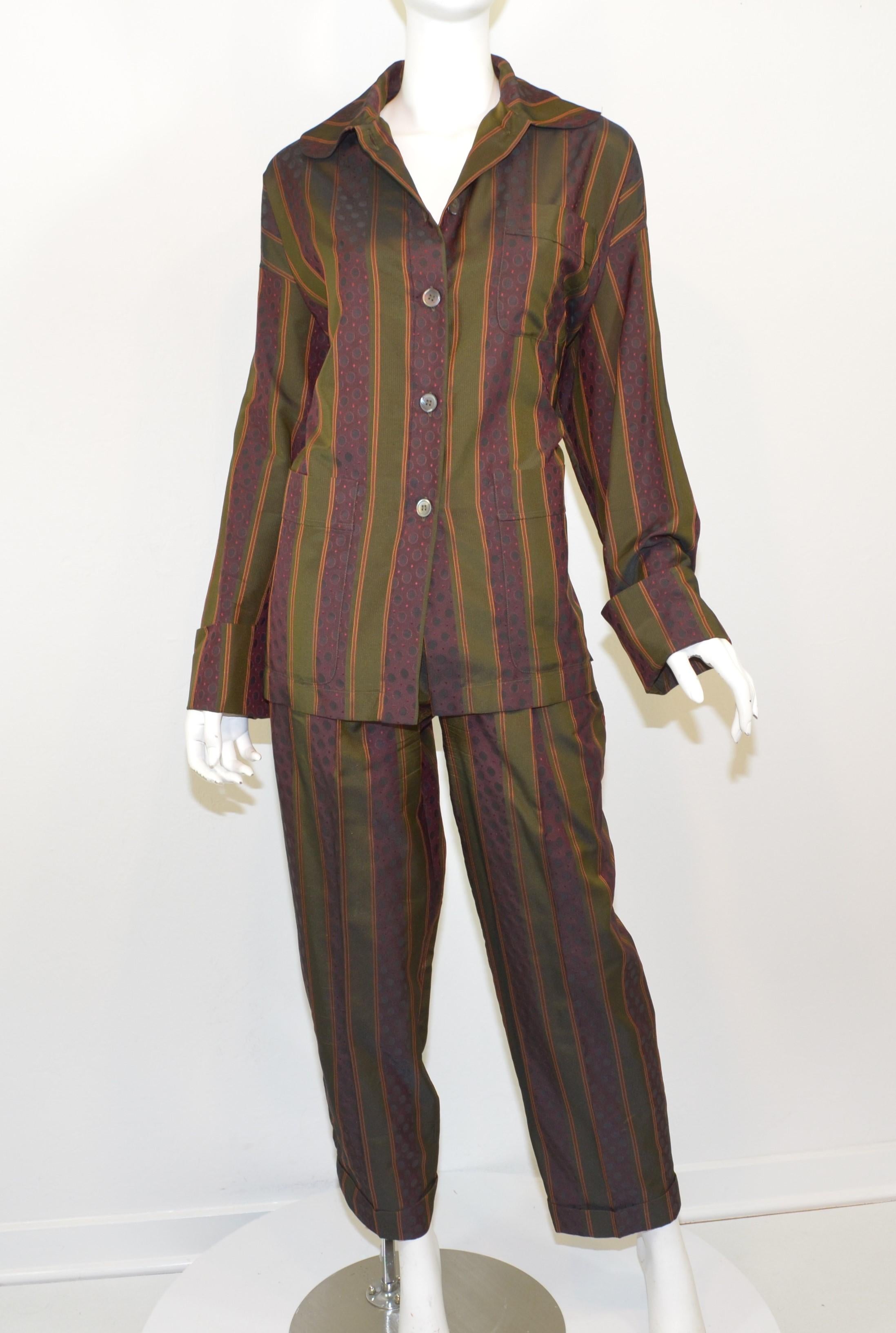 Romeo Gigli pant and top sleepwear set featured in olive green and maroon with an optical design throughout. Top has button fastenings and two functional pockets at the bust. Top is labeled size 42 and pants are a size 44. Set is composed with a