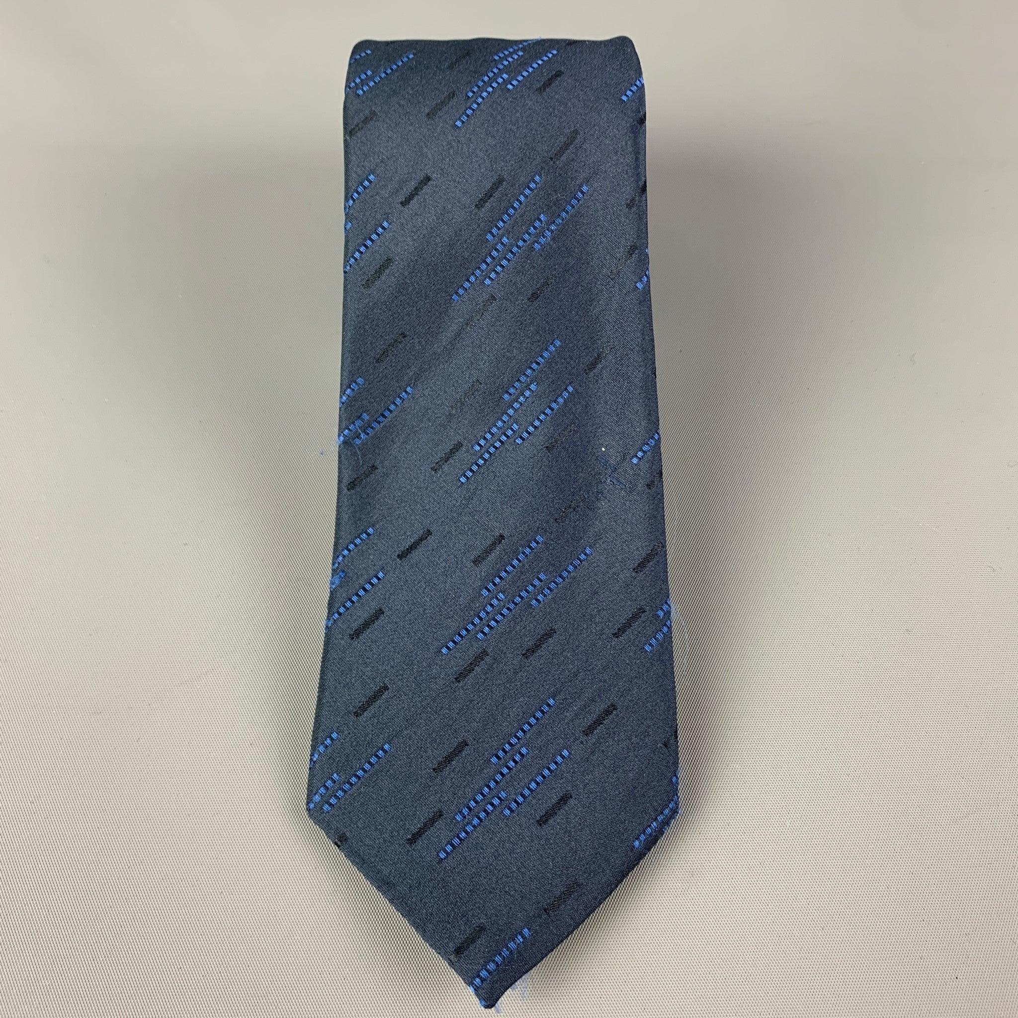 ROMEO GIGLI
 necktie comes in a navy & blue silk with a all over textured print. Made in Italy. Very Good Pre-Owned Condition. 
 

 Measurements: 
  Width: 3 inches Length: 60 inches 
  
  
  
 Sui Generis Reference: 119900
 Category: Tie
 More