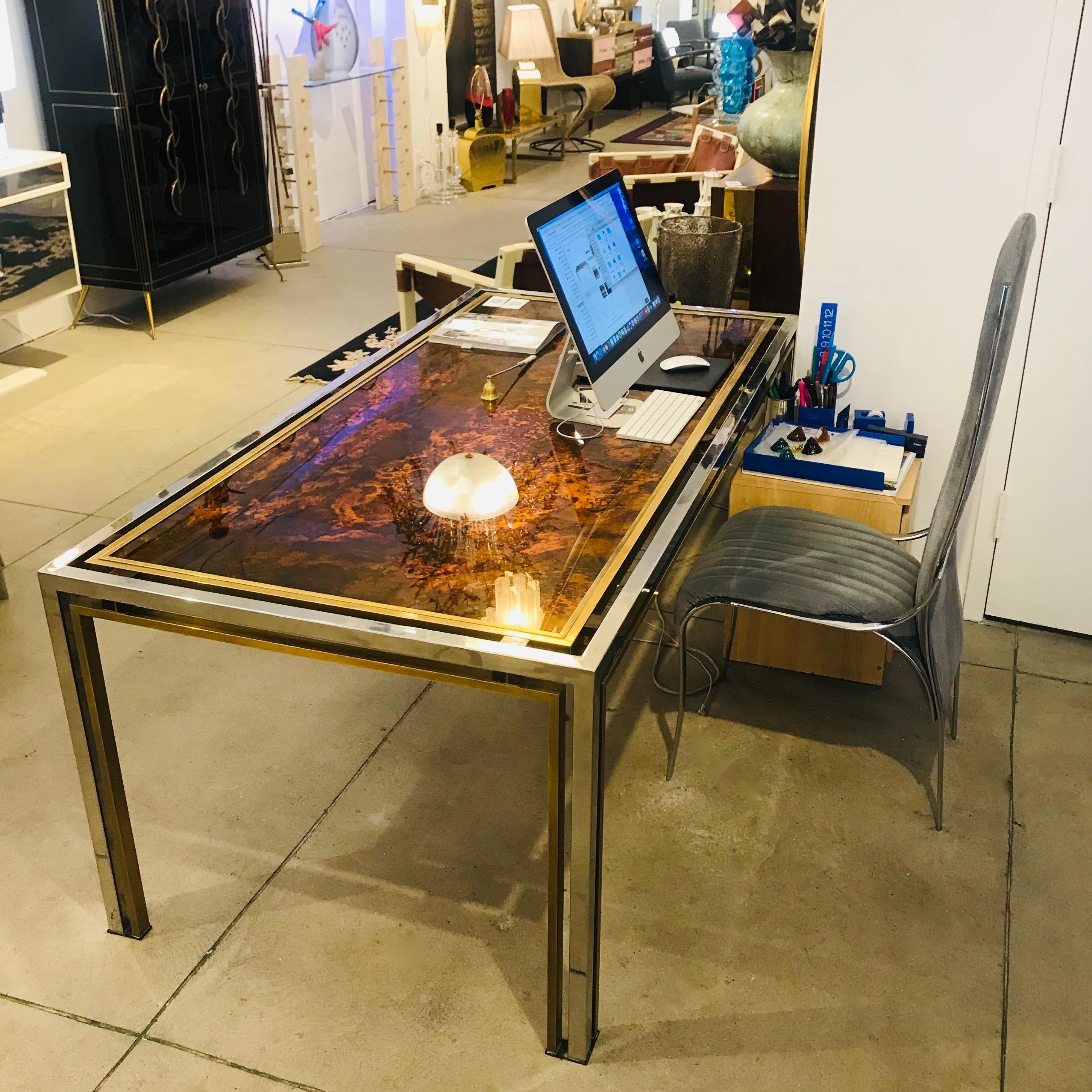 A superb table by Romeo Rega, very elegant with sophisticated Design and clean lines, the floating double-framed eglomise glass top is a magnificent Work of Art painted on reverse with faux tortoise decor of gold leaf inclusions and lacquer and is