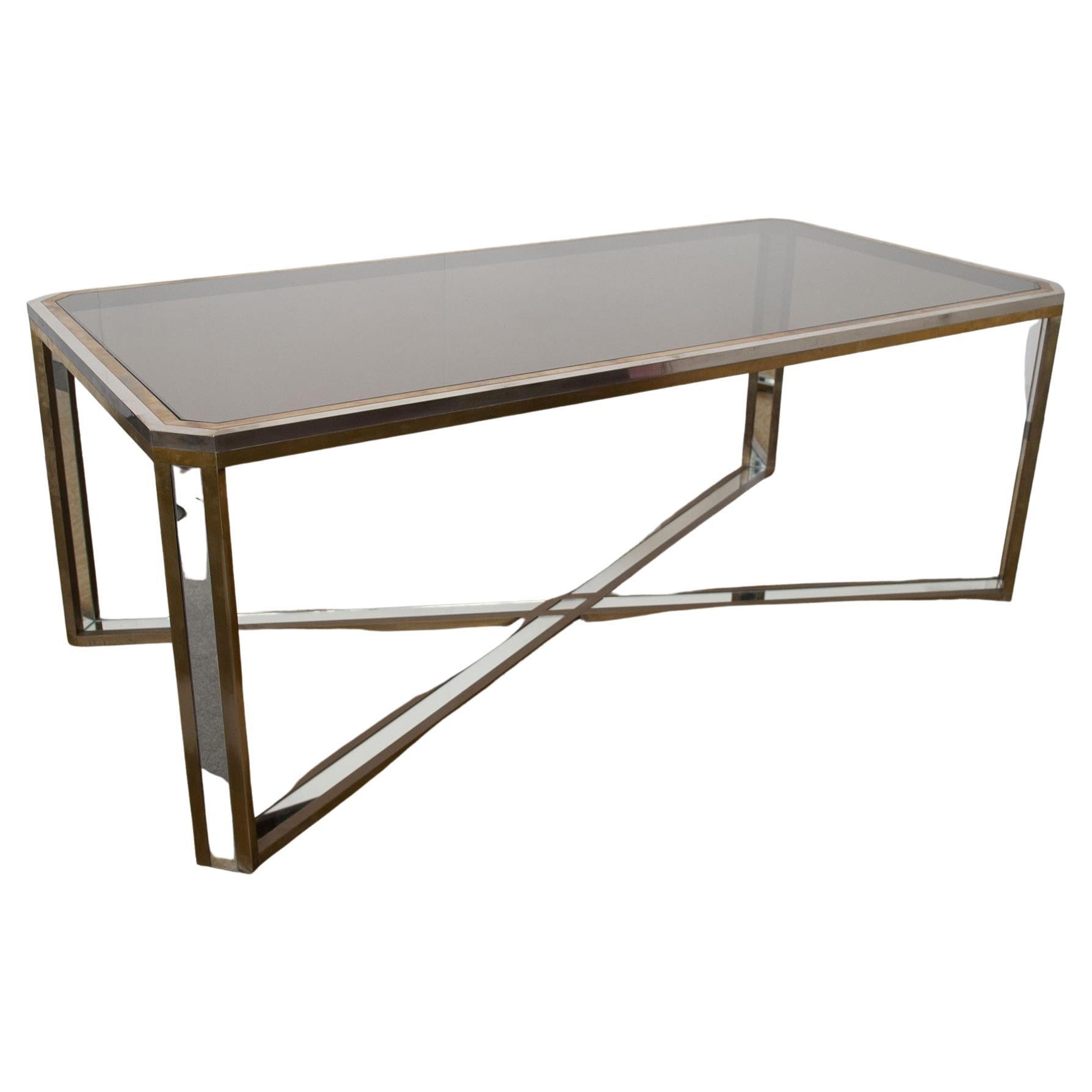 This spectacular table, designed by Romeo Rega, is made of steel, brass and mirrored glass.

Rega’s furniture is characterized by geometric shapes and reduced forms. His designs are almost always gilded, chromed, or brass-plated, which adds the