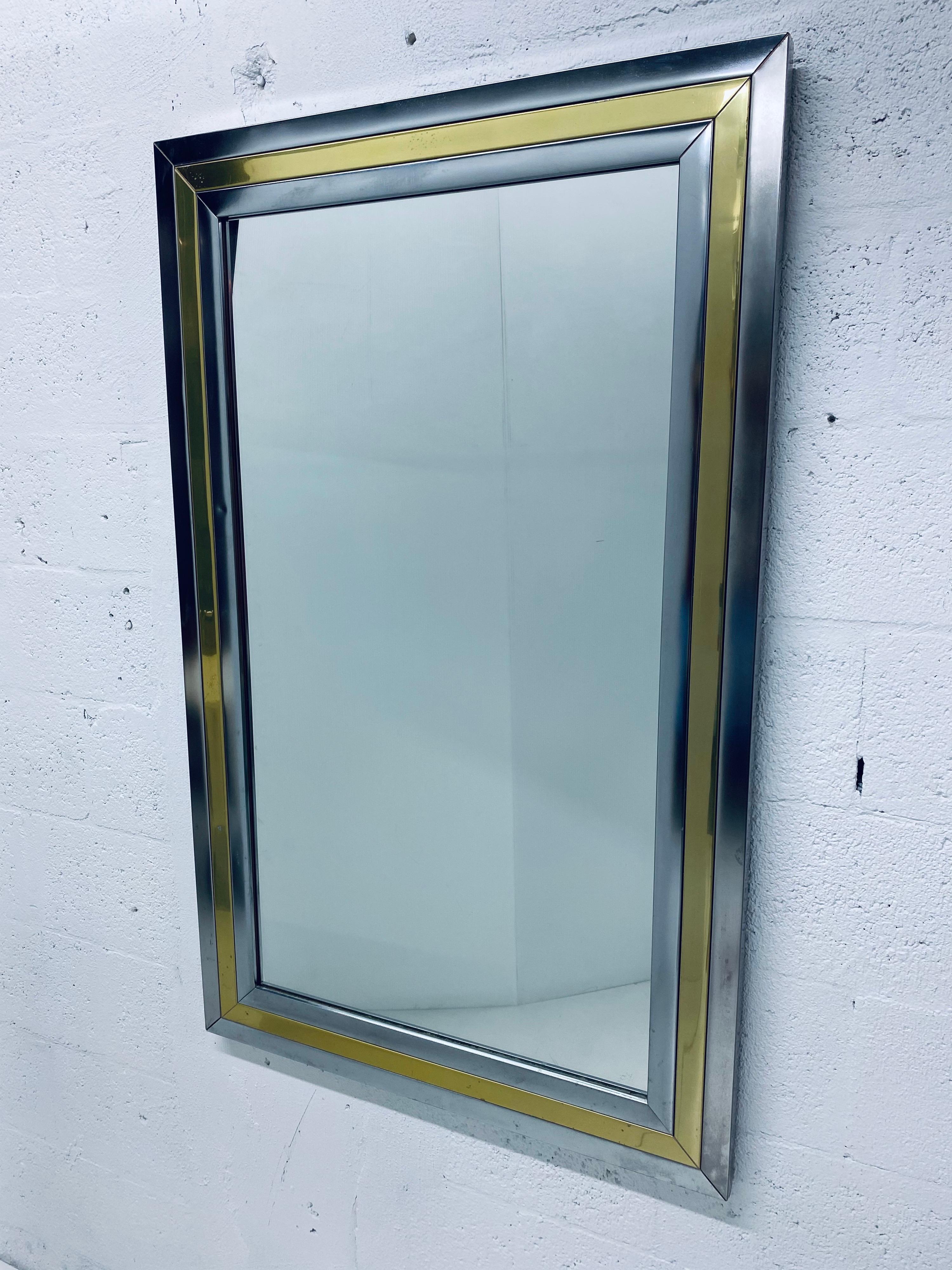 Large Mid-Century Modern wall mirror with chrome and brass banding attributed to Romeo Rega, 1970s. Can be hung vertical or horizontal.