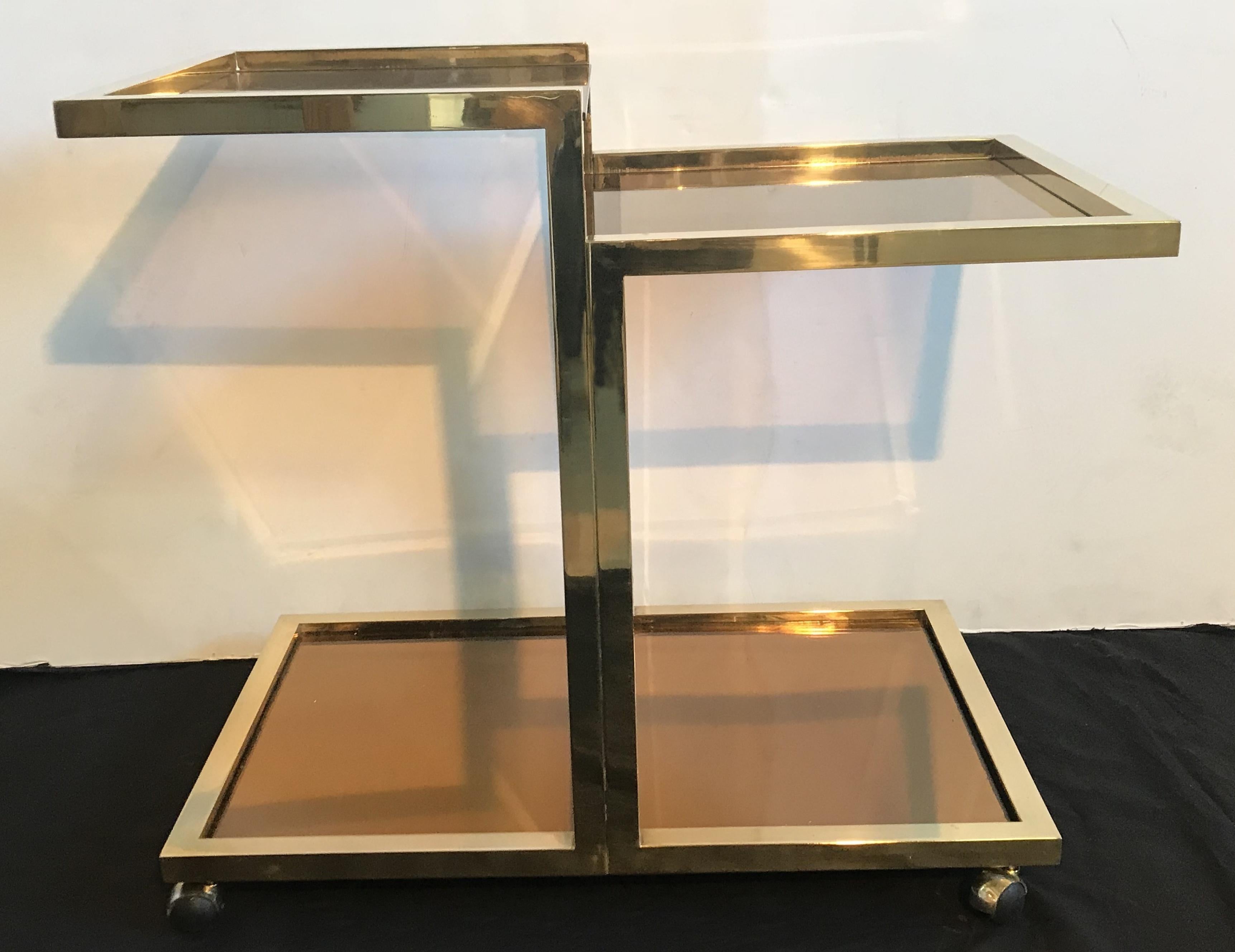 This elegant Romeo Rega cart has a brass frame construction with 3 smoked glass stories, on four wheels.

Born in 1904, Italian designer Romeo Rega is one of several 1970s designers that are associated with a combination of modernism and glamour