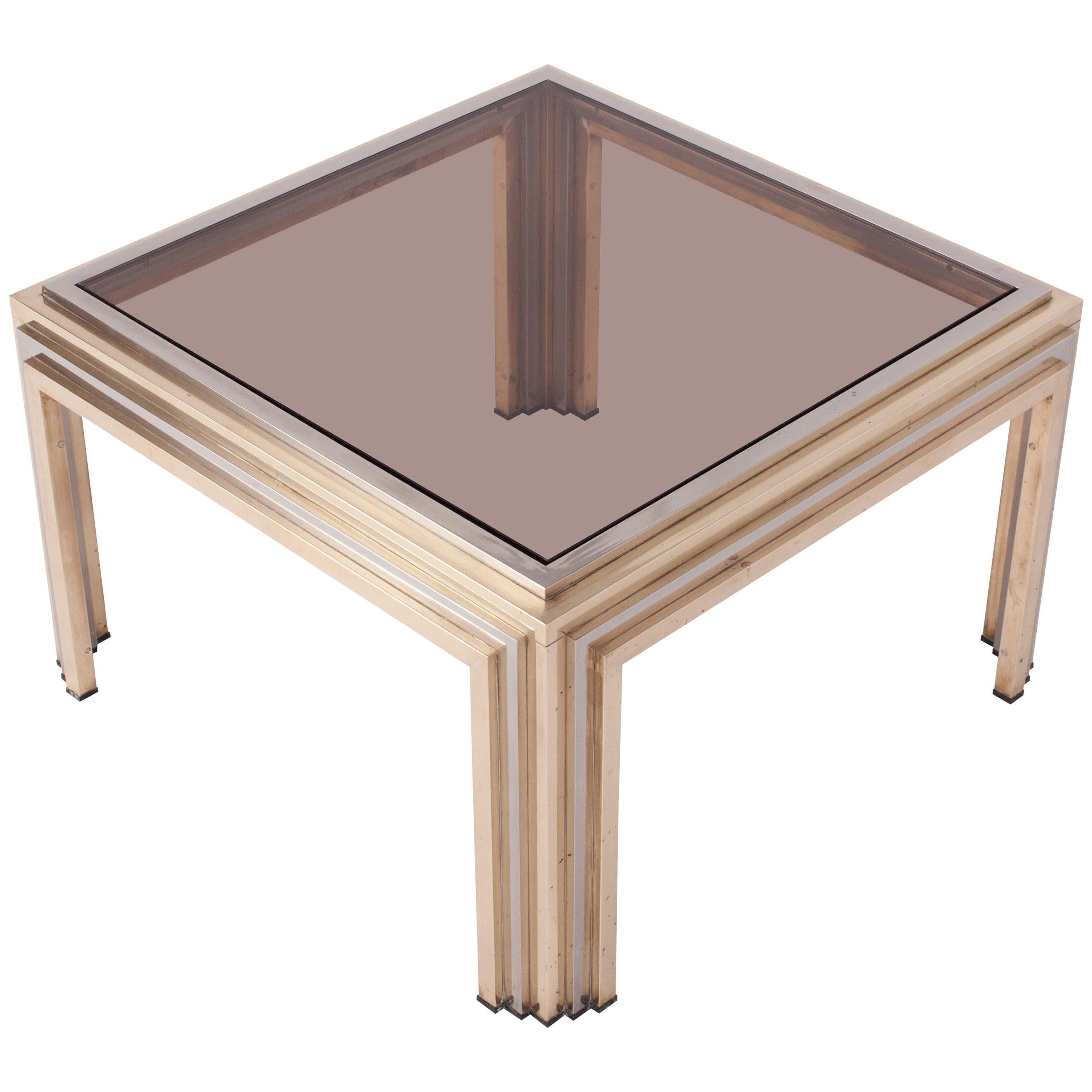 Brass and chrome eclectic coffee table by Romeo Rega
In the Hollywood Regency style of Maison Charles / Jansen
Italian glam from the 1970s
Smoked glass top.
 