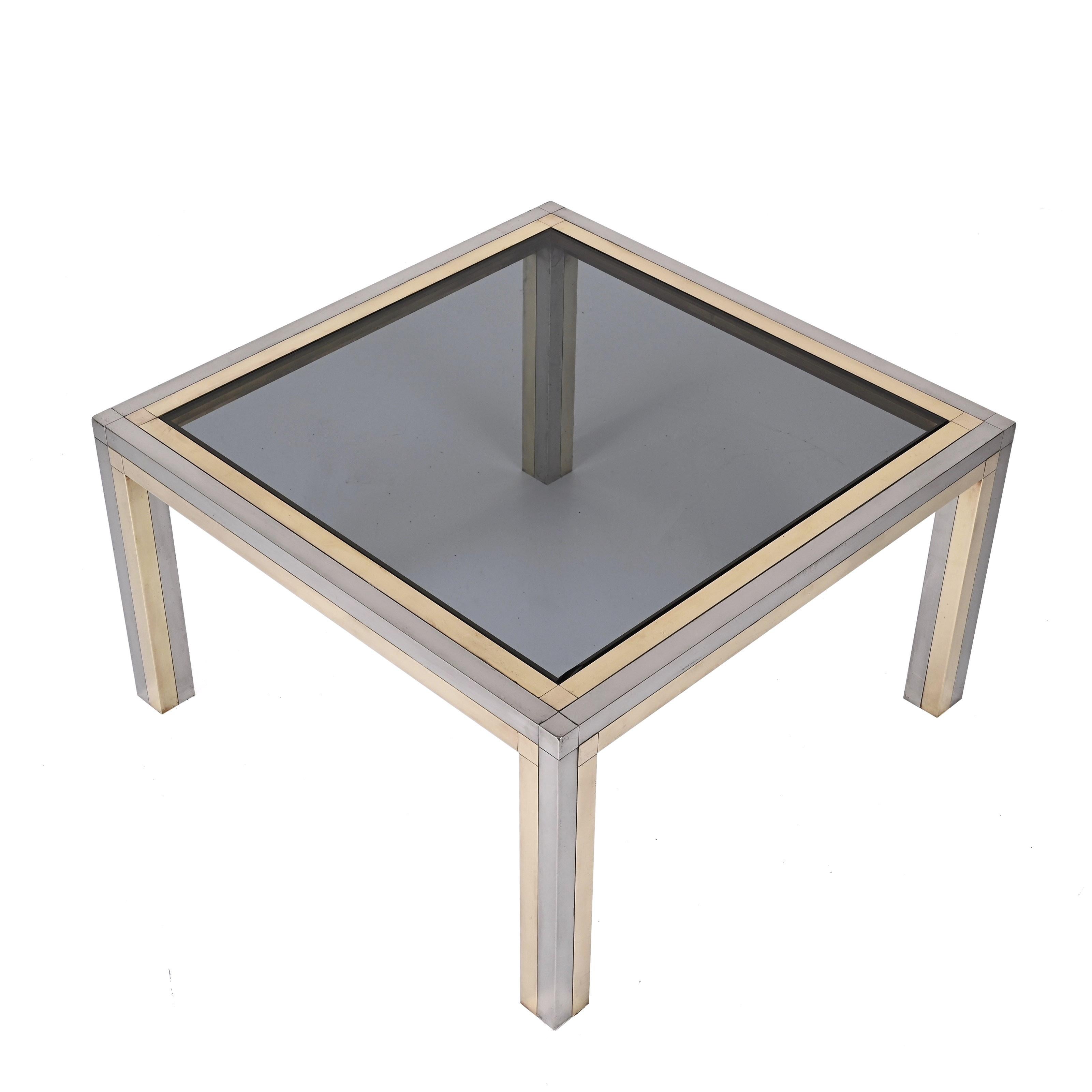 Elegant brass, chrome and smoked glass square coffee table. Romeo Rega designed this elegant coffee table during the 1970s in Italy.

The unique combination of straight and pure lines with superb materials, makes this item a go-to for Italian